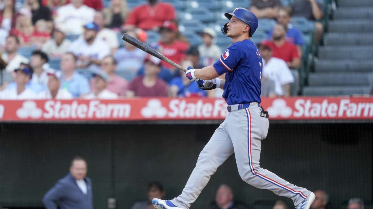 Texas Rangers' Corey Seager watches his two-run home run during the first inning of a baseball game against the Los Angeles Angels, Monday, July 8, 2024, in Anaheim, Calif.