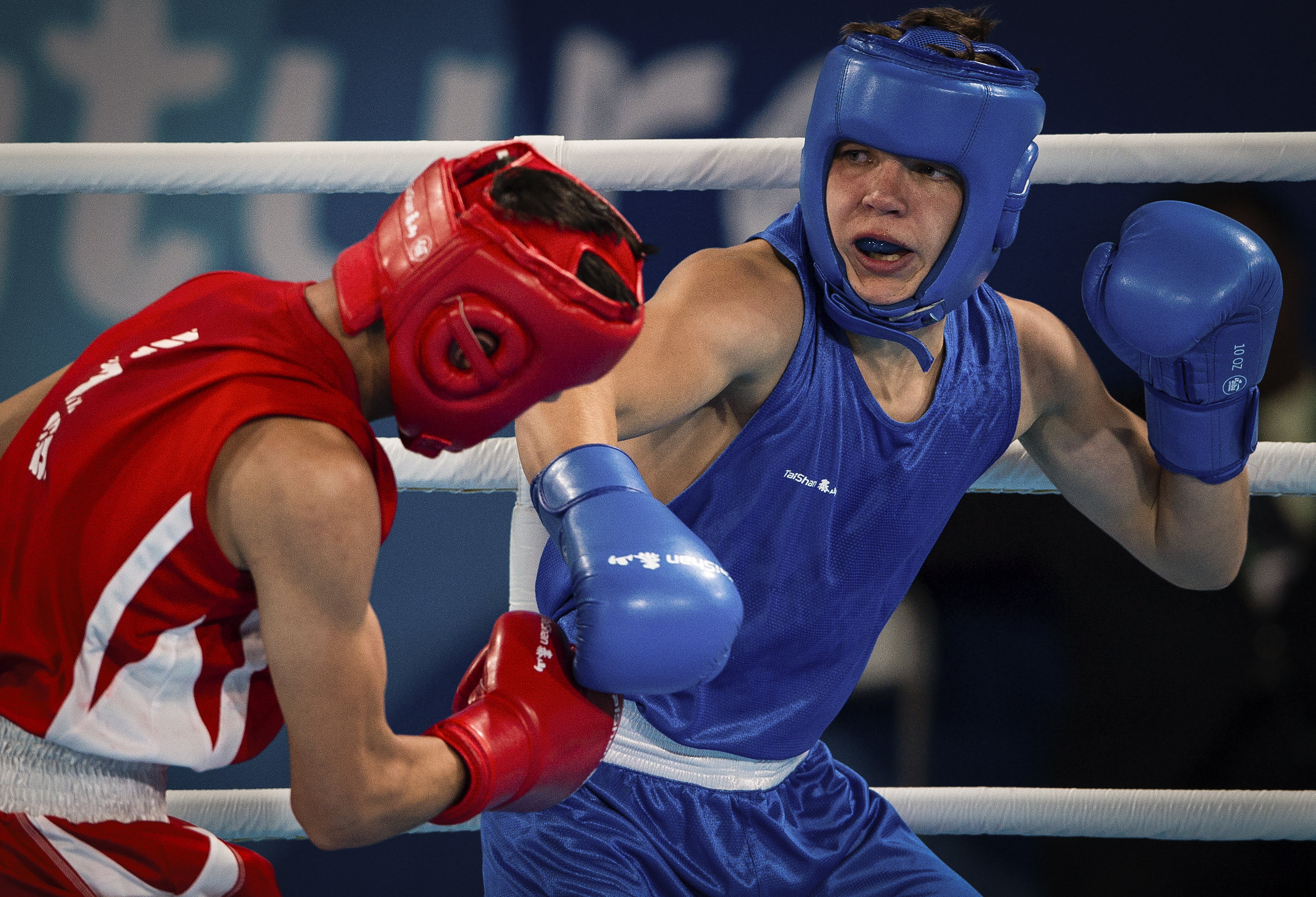 In this photo provided by the International Olympic Committee, Maksym Halinichev of Ukraine, right, competes against Abdumalik Khalokov of Uzbekistan in the Boxing Men's Bantam (56kg) Gold Medal Bout at the Oceania Pavilion of Youth Olympic Park during the Youth Olympic Games in Buenos Aires, Argentina, Thursday, Oct. 18, 2018. As one of Ukraine’s most promising boxing prospects, Halinichev could have been shielded from the war. 