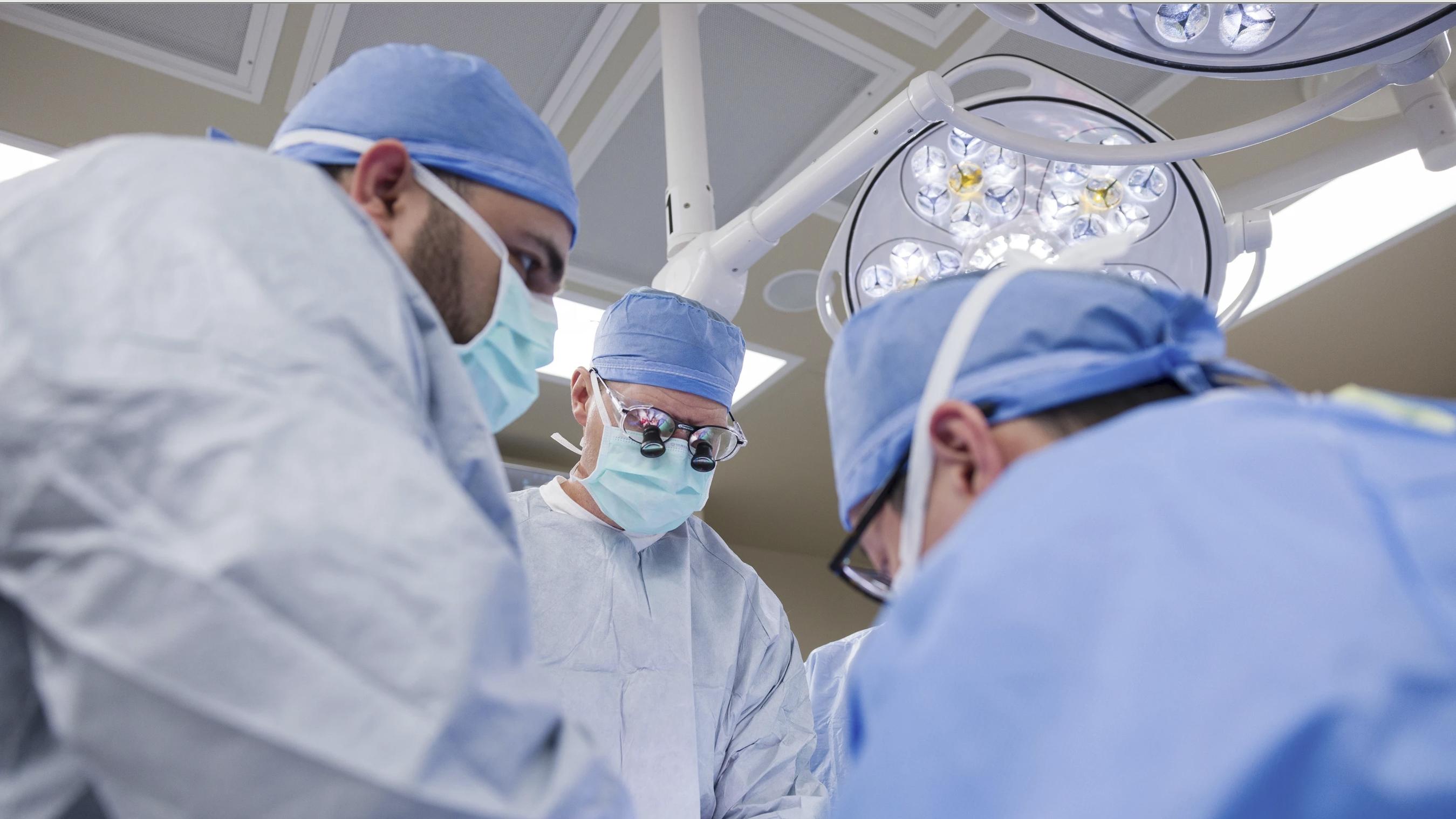 Dr. David Lott, center, and a multi-disciplinary team of doctors operate on Marty Kedian at Mayo Clinic Hospital in Phoenix, on Feb. 29.