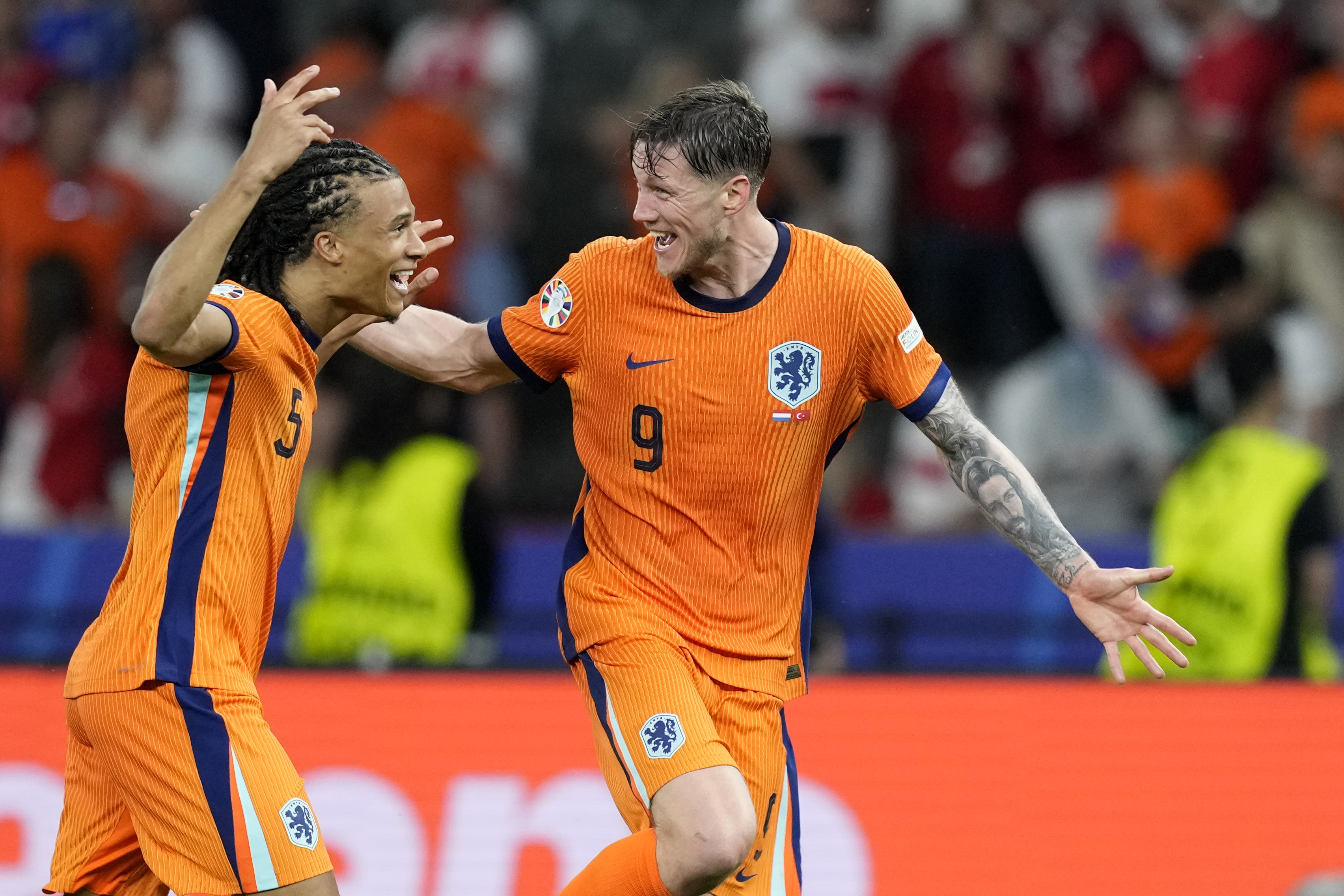 Wout Weghorst of the Netherlands, right, and Nathan Ake of the Netherlands celebrate after a quarterfinal match between the Netherlands and Turkey at the Euro 2024 soccer tournament in Berlin, Germany, Saturday, July 6, 2024. 