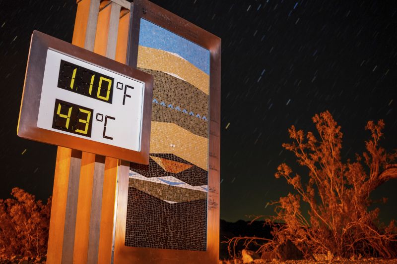 A long exposure image of the thermostat at the Furnace Creek Visitors Center after 10:00 p.m., in Death Valley National Park, Calif., Sunday. Forecasters say a heat wave could break previous records across the U.S., including in Death Valley.