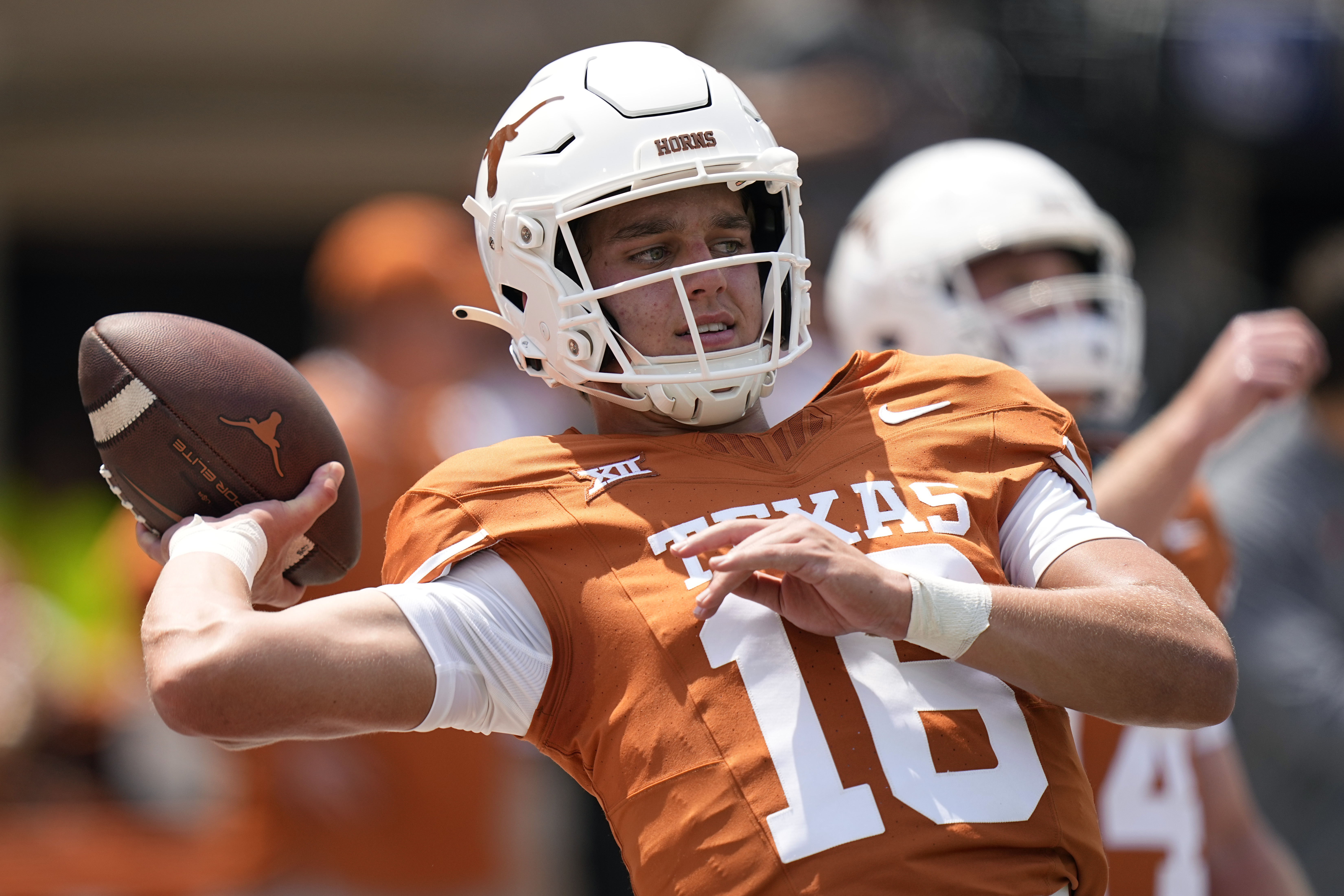 FILE - Texas quarterback Arch Manning (16) warms up before an NCAA college football game against Rice in Austin, Texas, Saturday, Sept. 2, 2023. Manning announced Tuesday, July 9, 2024, his likeness will be used in EA Sports College Football 25 following reports he had declined the game developer's offer to be featured in it.