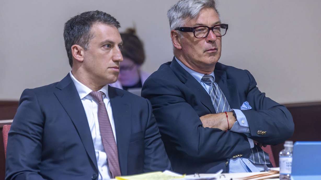 Attorney Alex Spiro, left, sits with Alec Baldwin during a preliminary hearing on Monday in court in Santa Fe, N.M. Baldwin's trial in the fatal shooting of a cinematographer is about to begin.