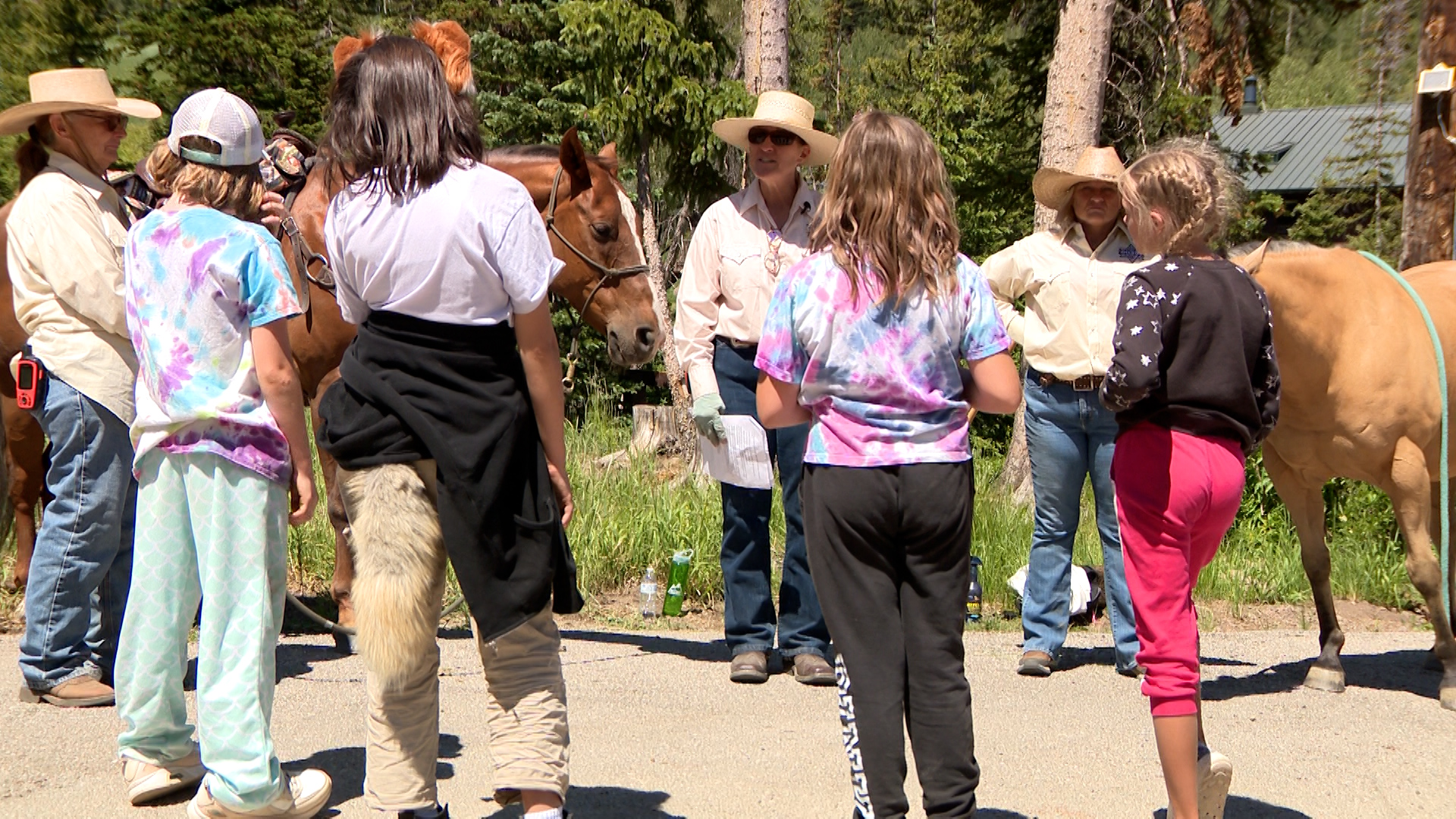 Some Camp Hope children listen to counselors Monday.