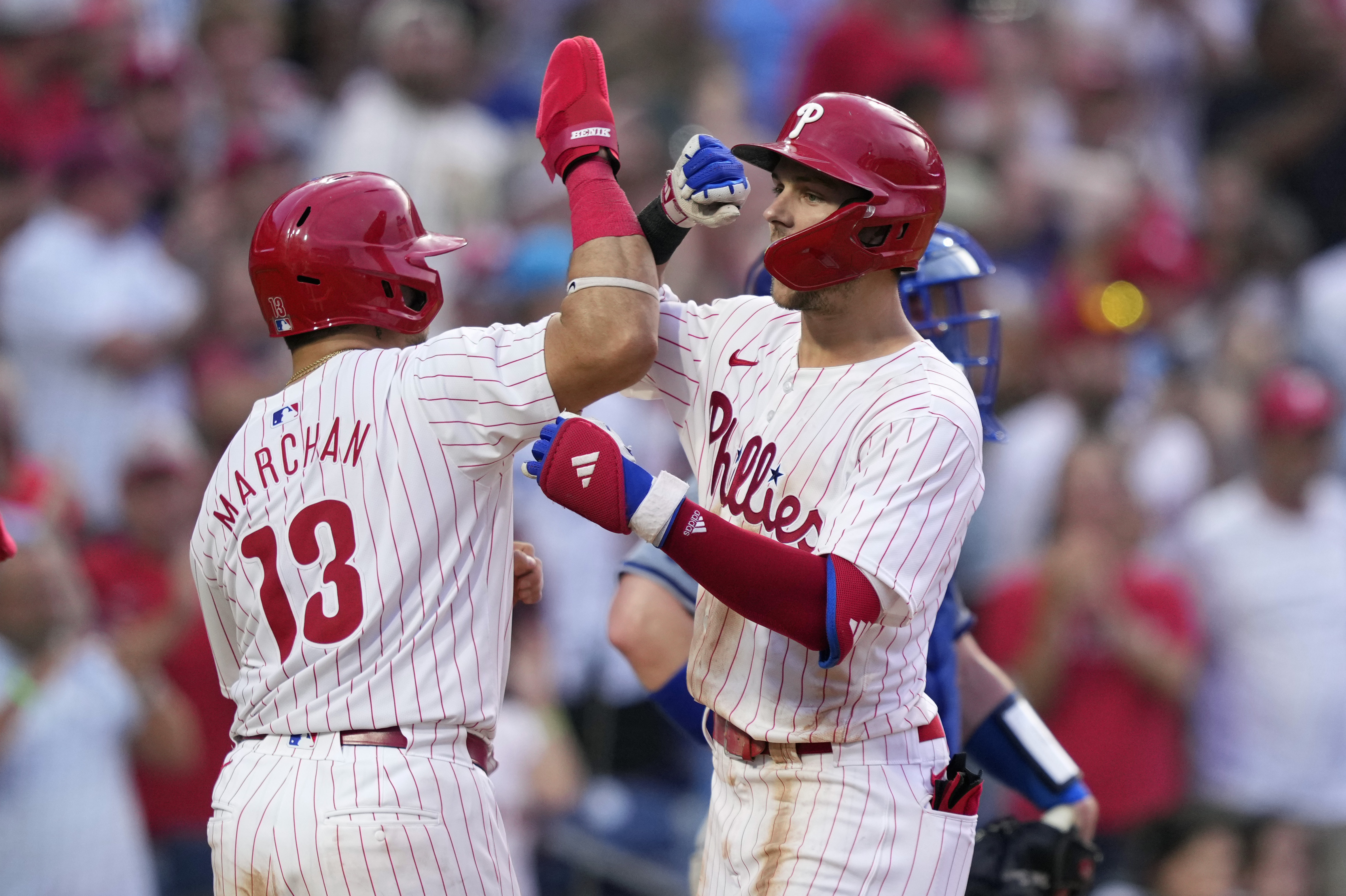 Philadelphia Phillies' Trea Turner, right, and Rafael Marchán celebrate after Turner's grand slam against Los Angeles Dodgers pitcher Bobby Miller during the fourth inning of a baseball game, Tuesday, July 9, 2024, in Philadelphia. 
