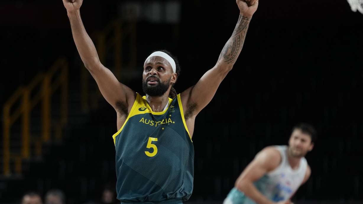 FILE - Australia's Patty Mills (5) reacts as time runs down against Slovenia during the men's bronze medal basketball game at the 2020 Summer Olympics, Saturday, Aug. 7, 2021, in Tokyo, Japan. The Australian Olympic team said their team is also likely to be the third-largest delegation at the Paris Olympics — despite its relatively small population of 26 million. Ten Indigenous athletes will also represent Australia with NBA star Patty Mills the first five-time Indigenous Olympian.