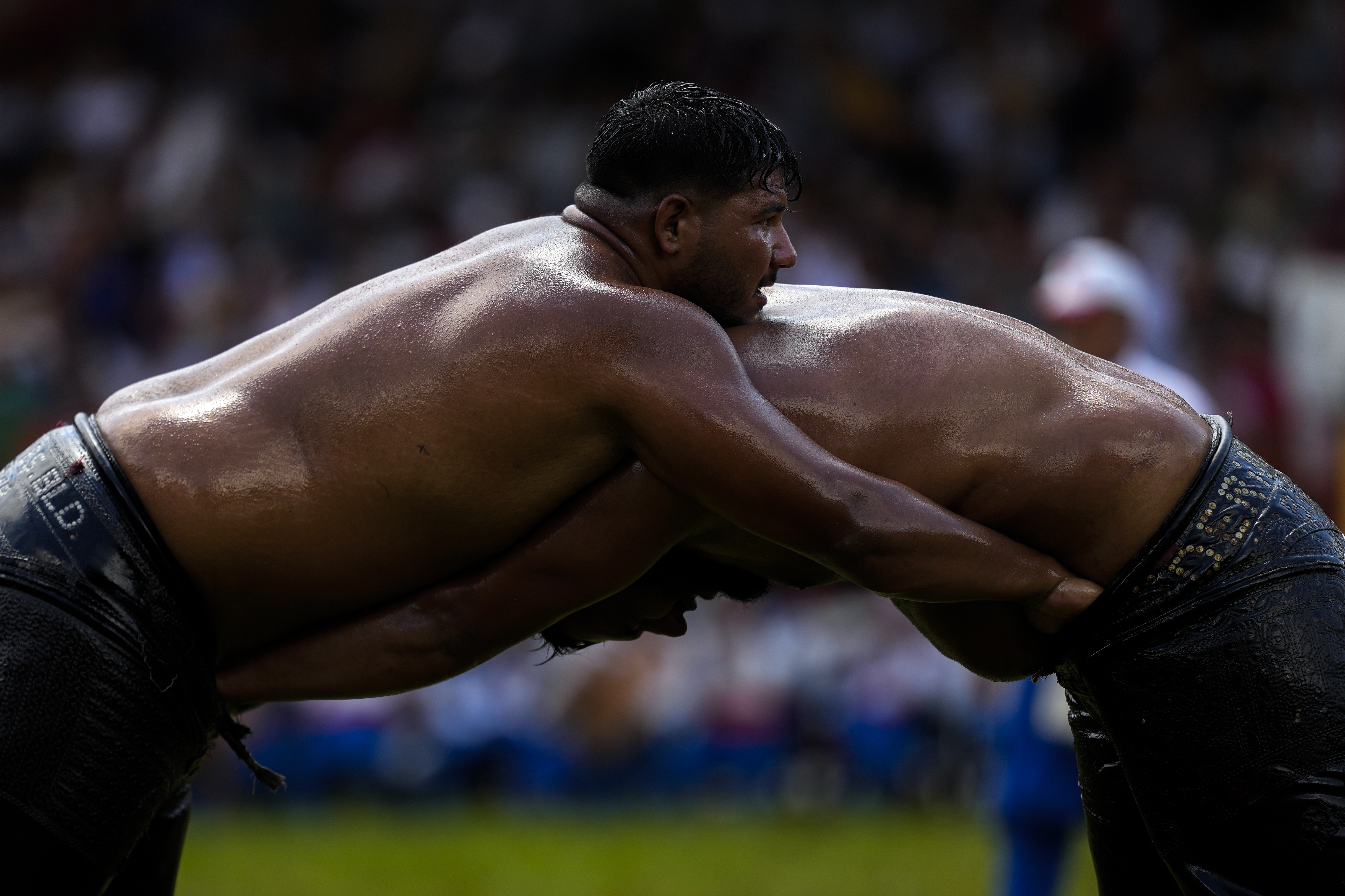 Wrestlers compete during the 663rd annual Historic Kirkpinar Oil Wrestling championship, in Edirne, northwestern Turkey, Saturday, July 6, 2024. Wrestlers take part in this "sudden death"-style traditional competition wearing only a pair of leather trousers and a good slick of olive oil. The festival is part of UNESCO's List of Intangible Cultural Heritages. 