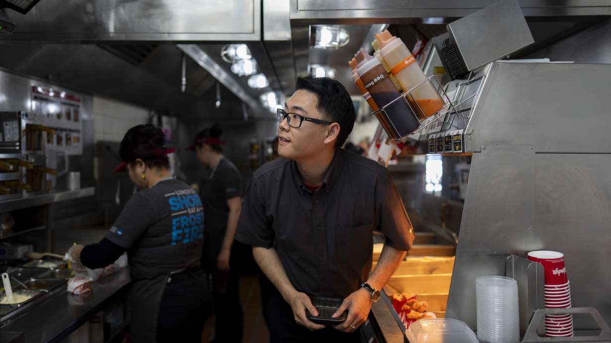Lawrence Cheng works in the kitchen at his Wendy's restaurant in Fountain Valley, Calif., June 20. Cheng used to have nearly a dozen employees at his Fountain Valley location during the day. Now, he only schedules seven for each shift.
