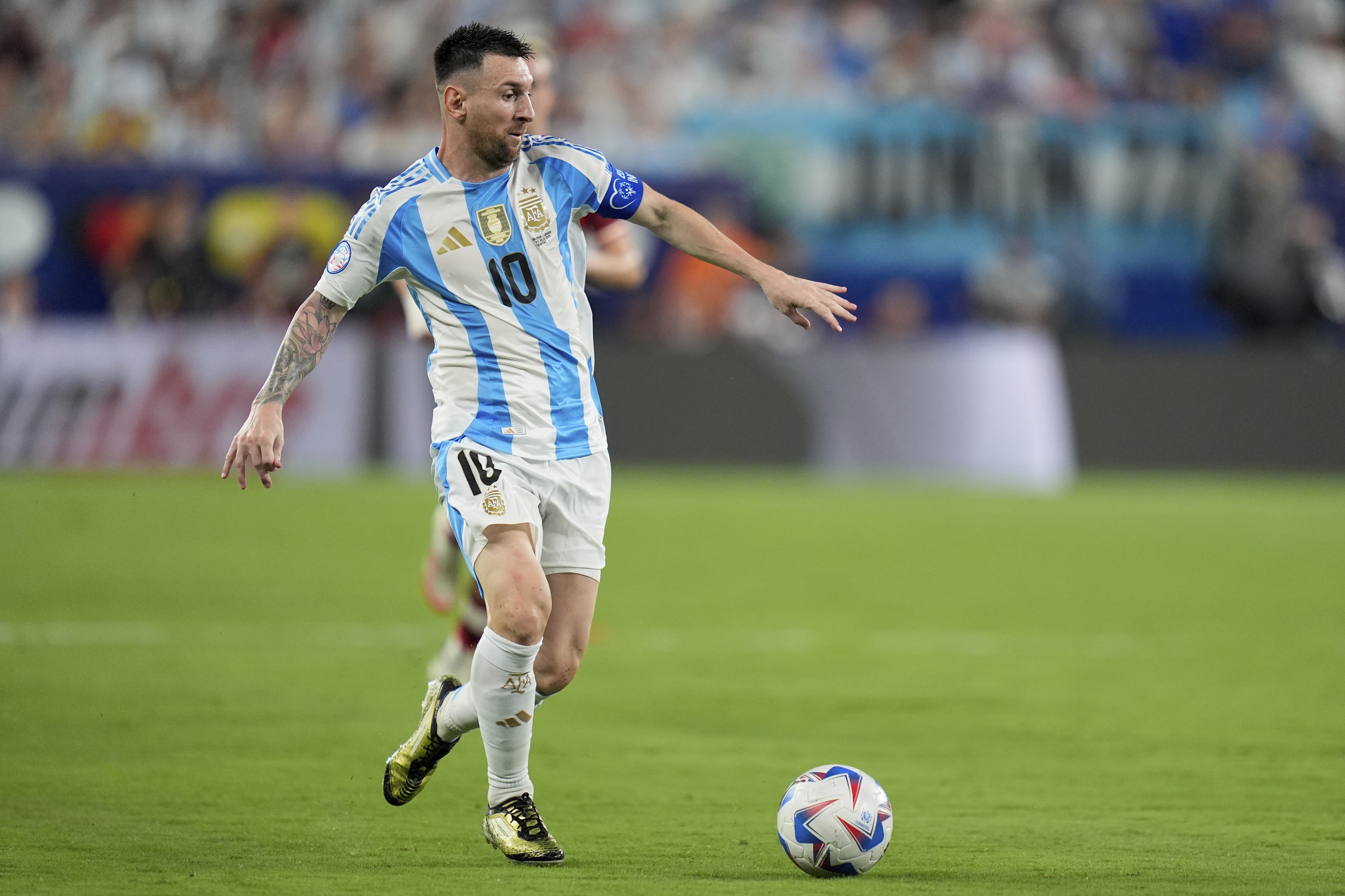 Argentina's Lionel Messi dribbles during a Copa America semifinal soccer match against Canada in East Rutherford, N.J., Tuesday, July 9, 2024.