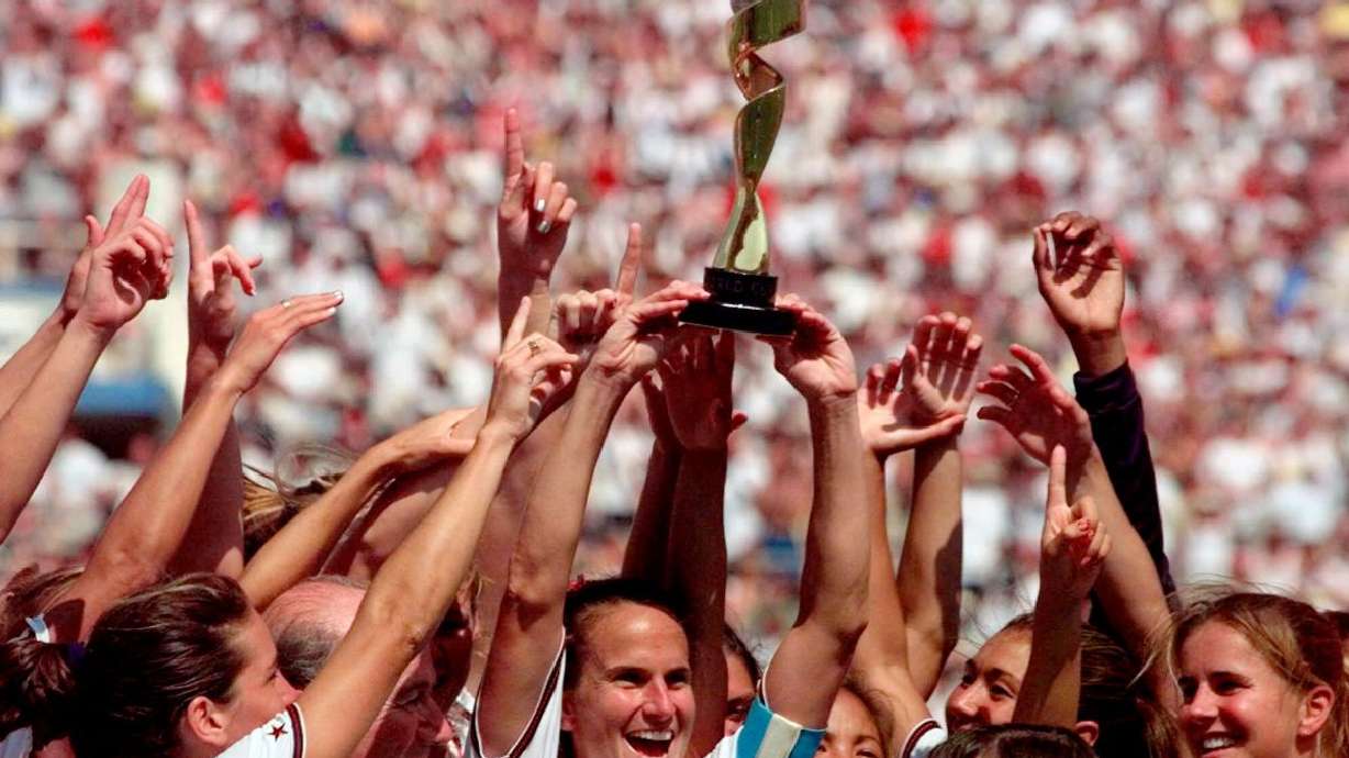 United States soccer team captain Carla Overbeck, center, the U.S. team and FIFA President Sepp Blatter, left, of Overbeck, celebrate with the trophy after defeating China in a 5-4 in a penalty shootout in the Women's World Cup final soccer match at the Rose Bowl in Pasadena, Calif., July 10, 1999. Players on the team paved the way for better pay and equitable treatment for women.