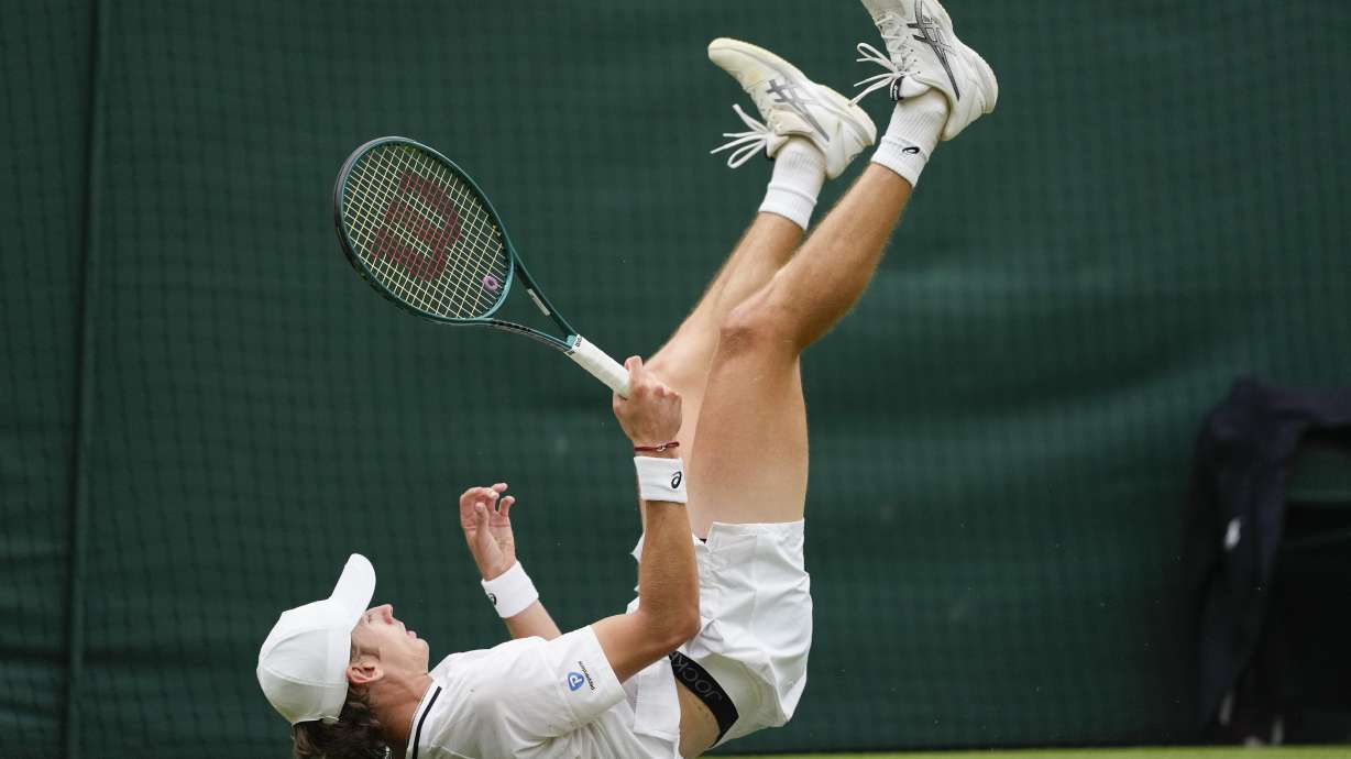 Alex de Minaur of Australia falls during his fourth round match against Arthur Fils of France at the Wimbledon tennis championships in London, Monday, July 8, 2024.