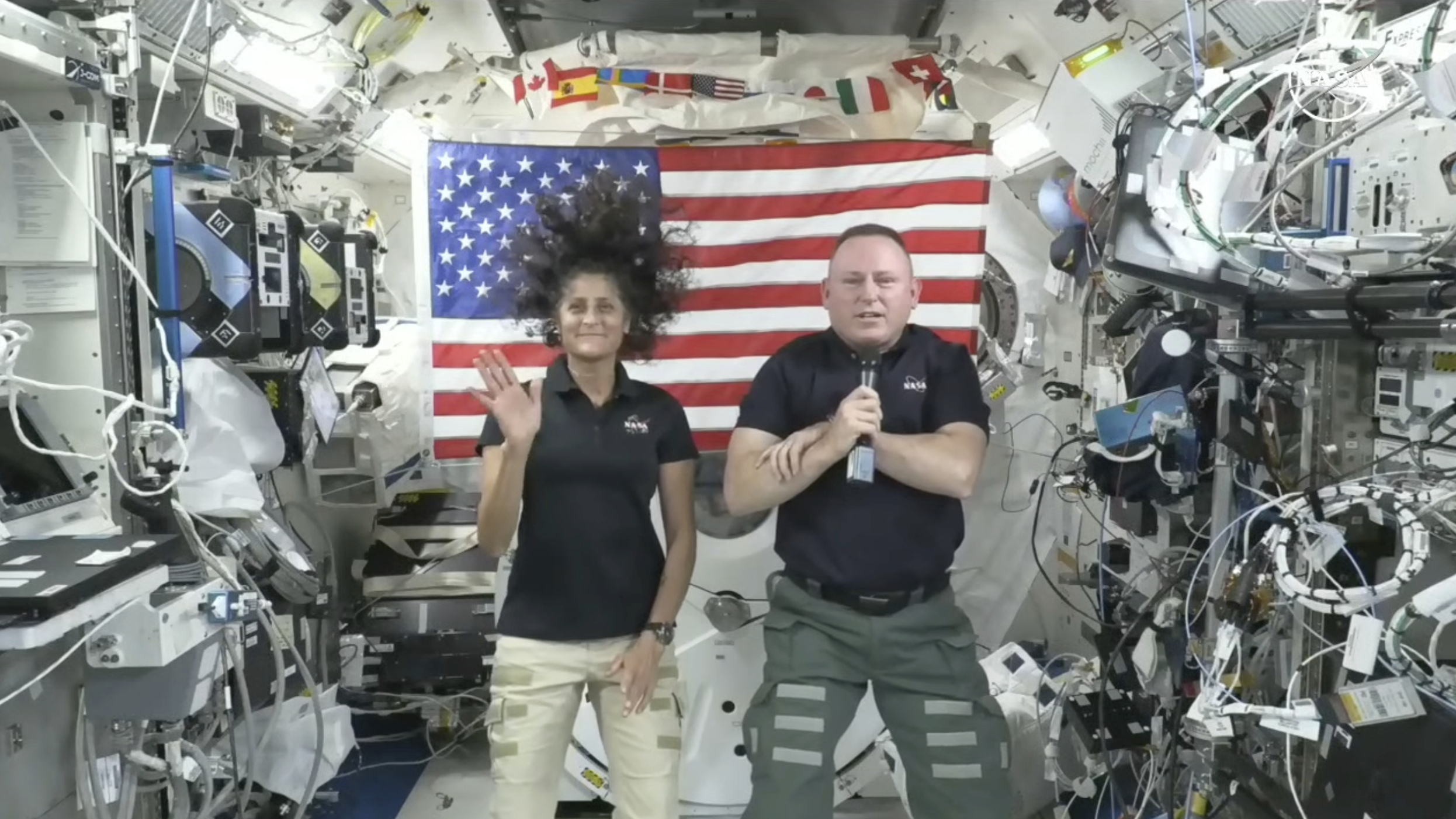 In this image from video provided by NASA, astronauts Suni Williams, left, and Butch Wilmore give a news conference aboard the International Space Station on Wednesday.