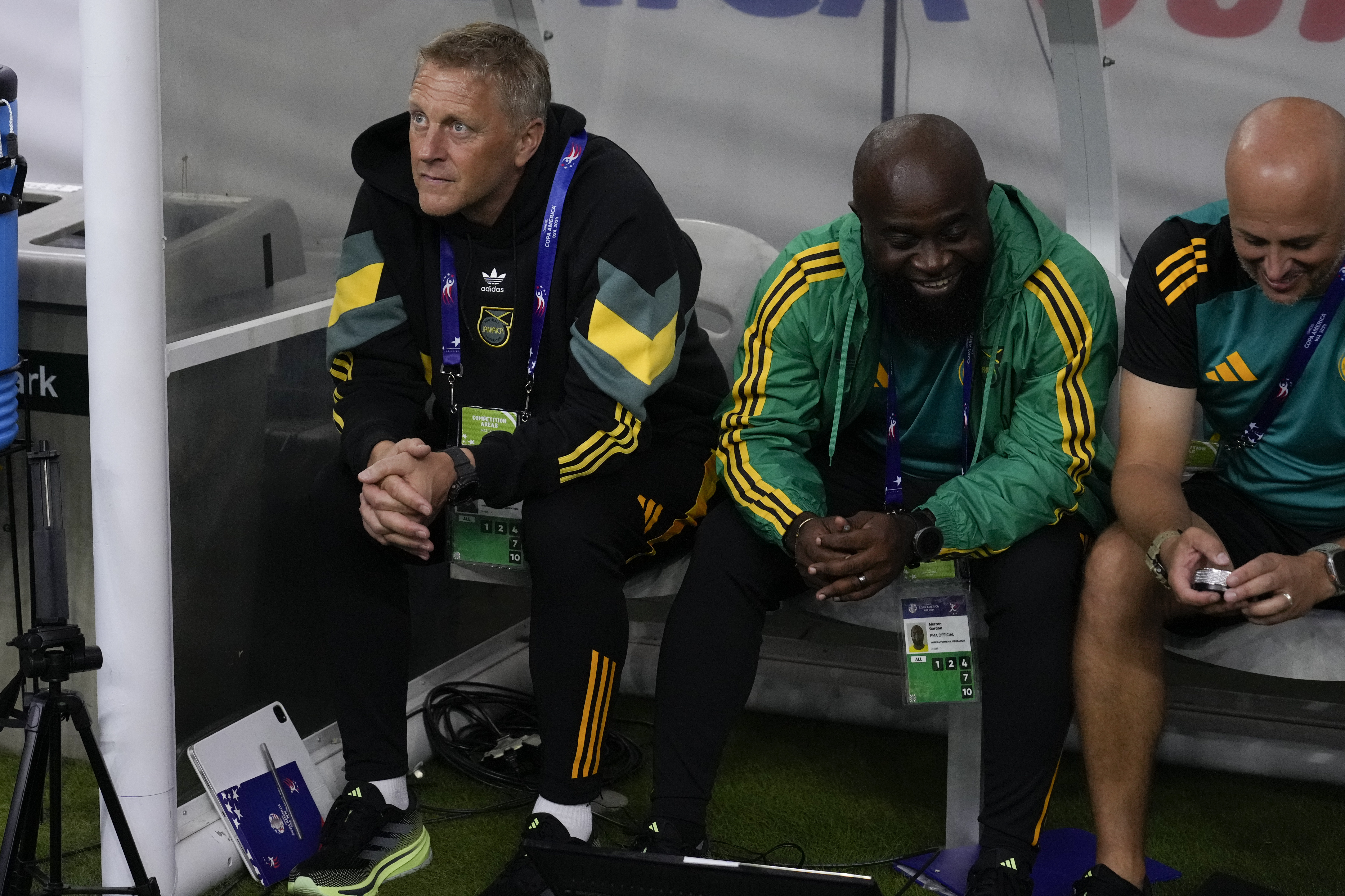 Jamaica's coach Heimir Hallgrimsson, left, sits on the bench prior to a Copa America Group B soccer match against Mexico in Houston, Texas, Saturday, June 22, 2024.