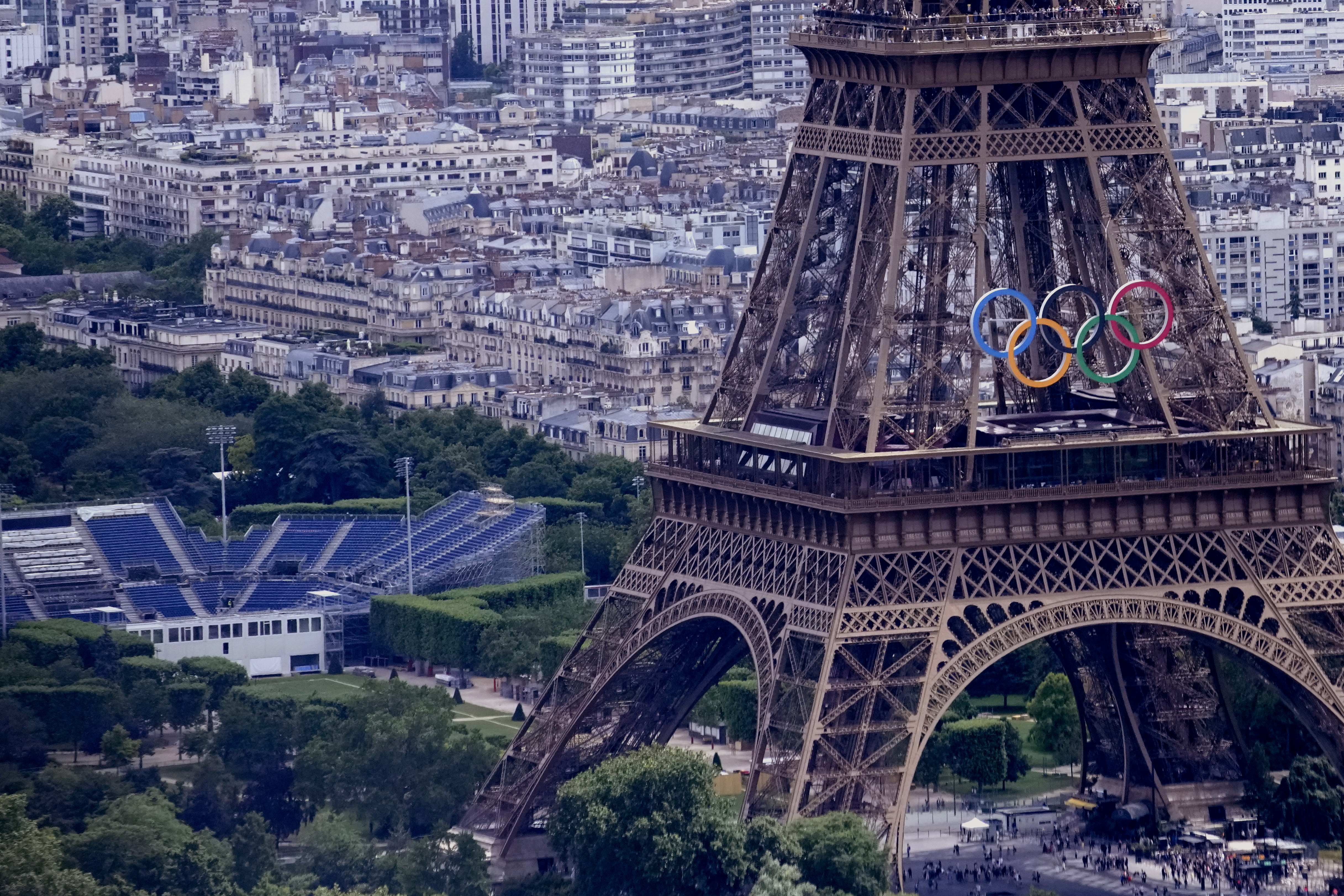 The Olympic rings are seen on the Eiffel Tower in Paris, France, Monday, June 17, 2024. The Champ-de-Mars at left will host the Beach Volleyball and Blind Football at the Paris 2024 Olympic and Paralympic Games. 