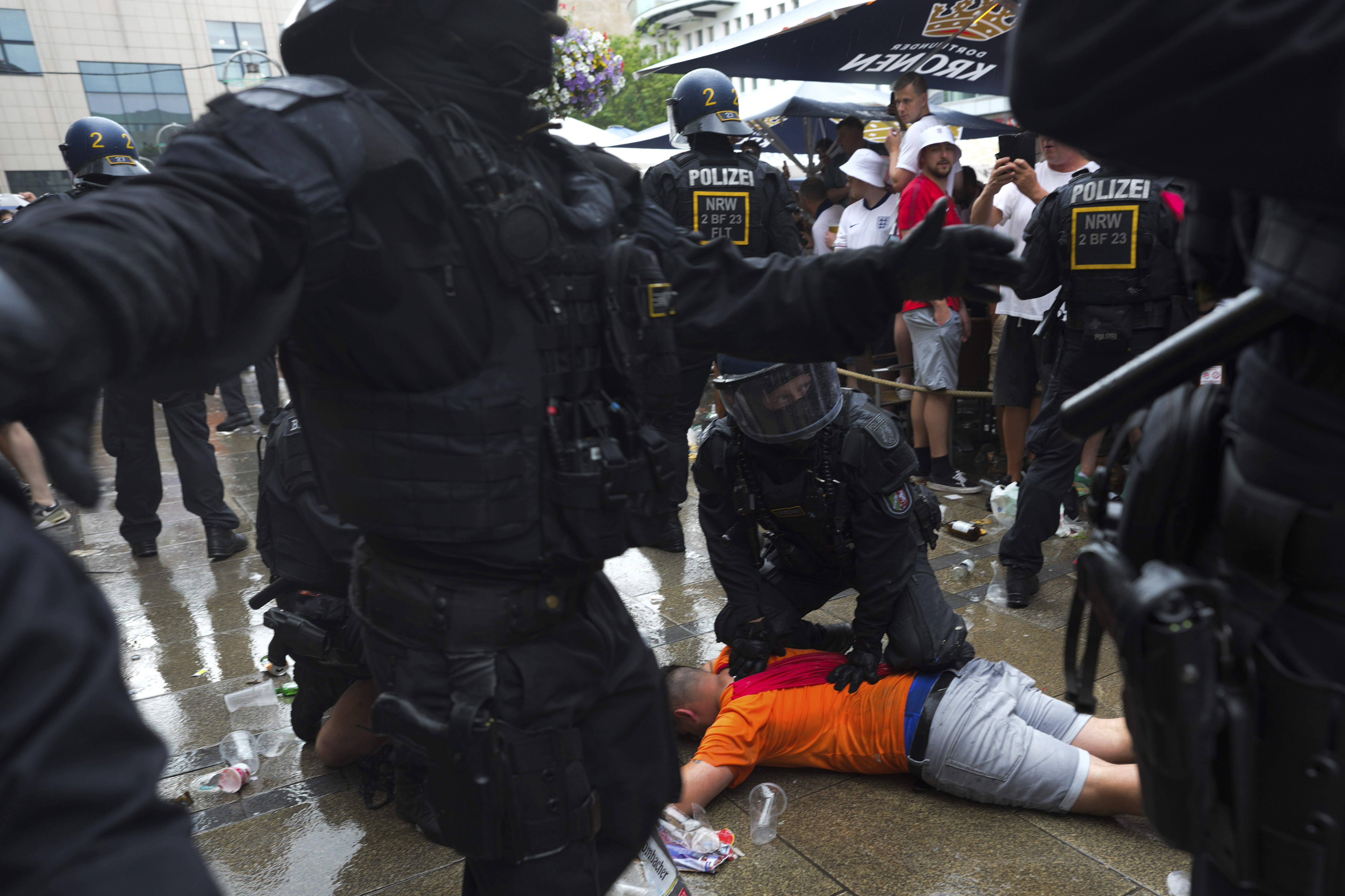 Police officers detain a soccer fan ahead of a semi final match between Netherlands and England at the Euro 2024 soccer tournament in Dortmund, Germany, Wednesday, July 10, 2024.