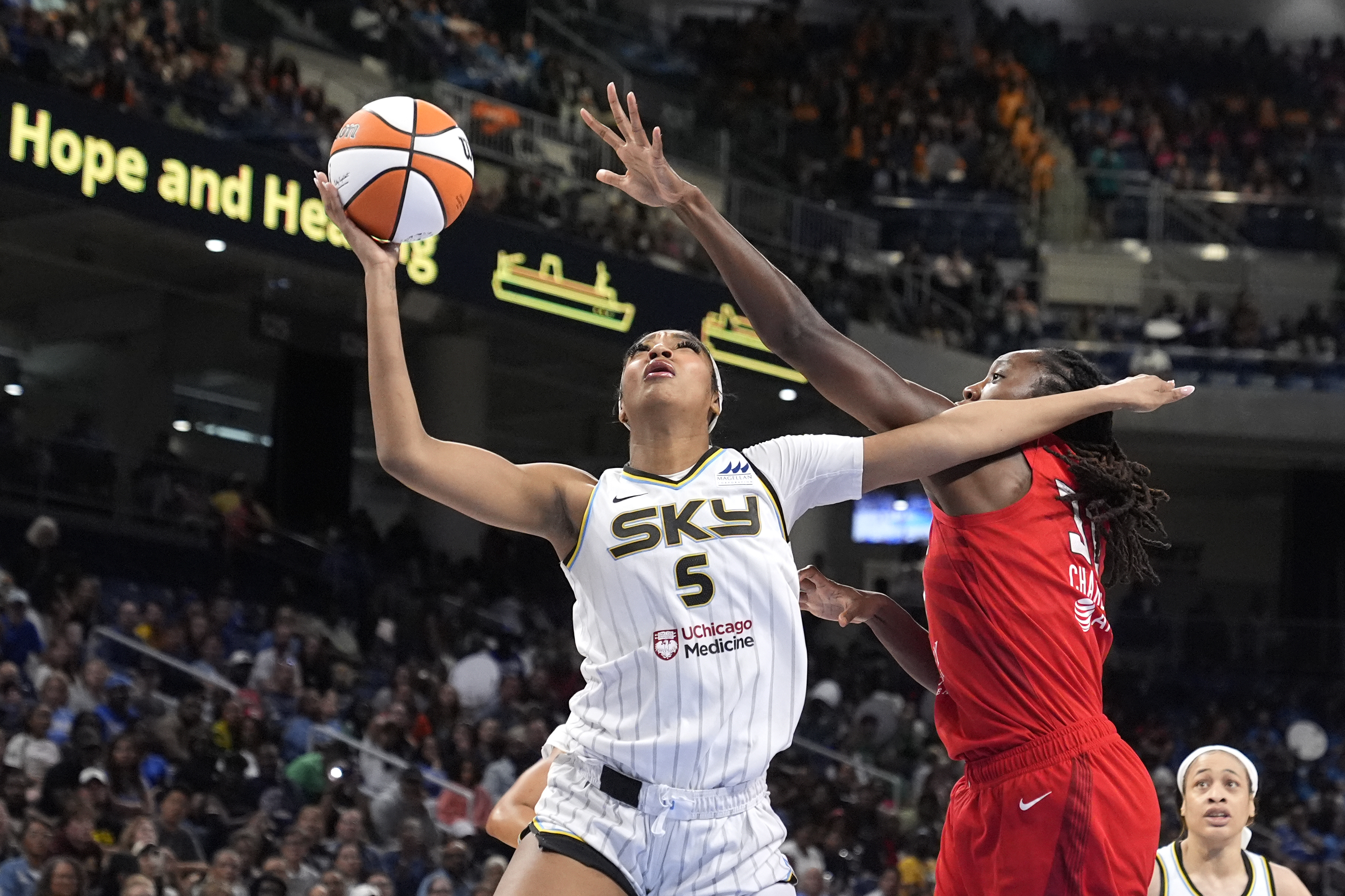 Chicago Sky's Angel Reese (5) shoots past the out stretch arm of Atlanta Dream's Tina Charles during the second half of a WNBA basketball game Wednesday, July 10, 2024, in Chicago. The Sky won 78-69. 