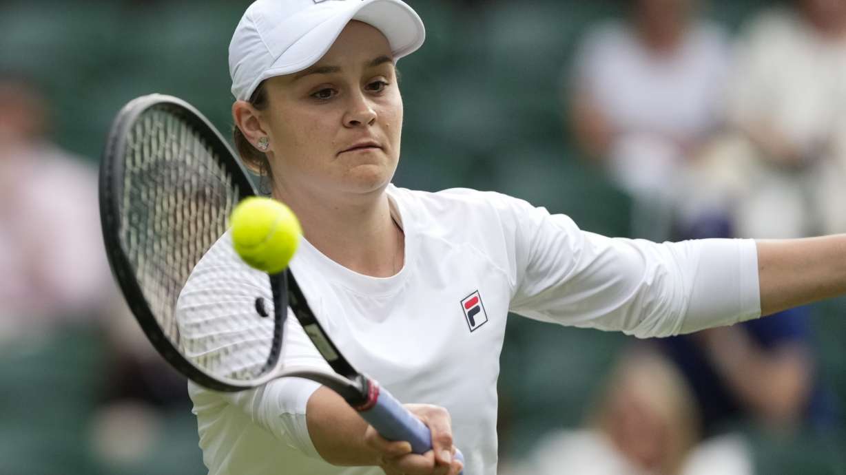 Australia's Ash Barty plays a forehand return during her invitation doubles match with compatriot Casey Dellacqua against Andrea Petkovic of Germany and Magdelena Rybarikova of Slovakia at the Wimbledon tennis championships in London, Wednesday, July 10, 2024.