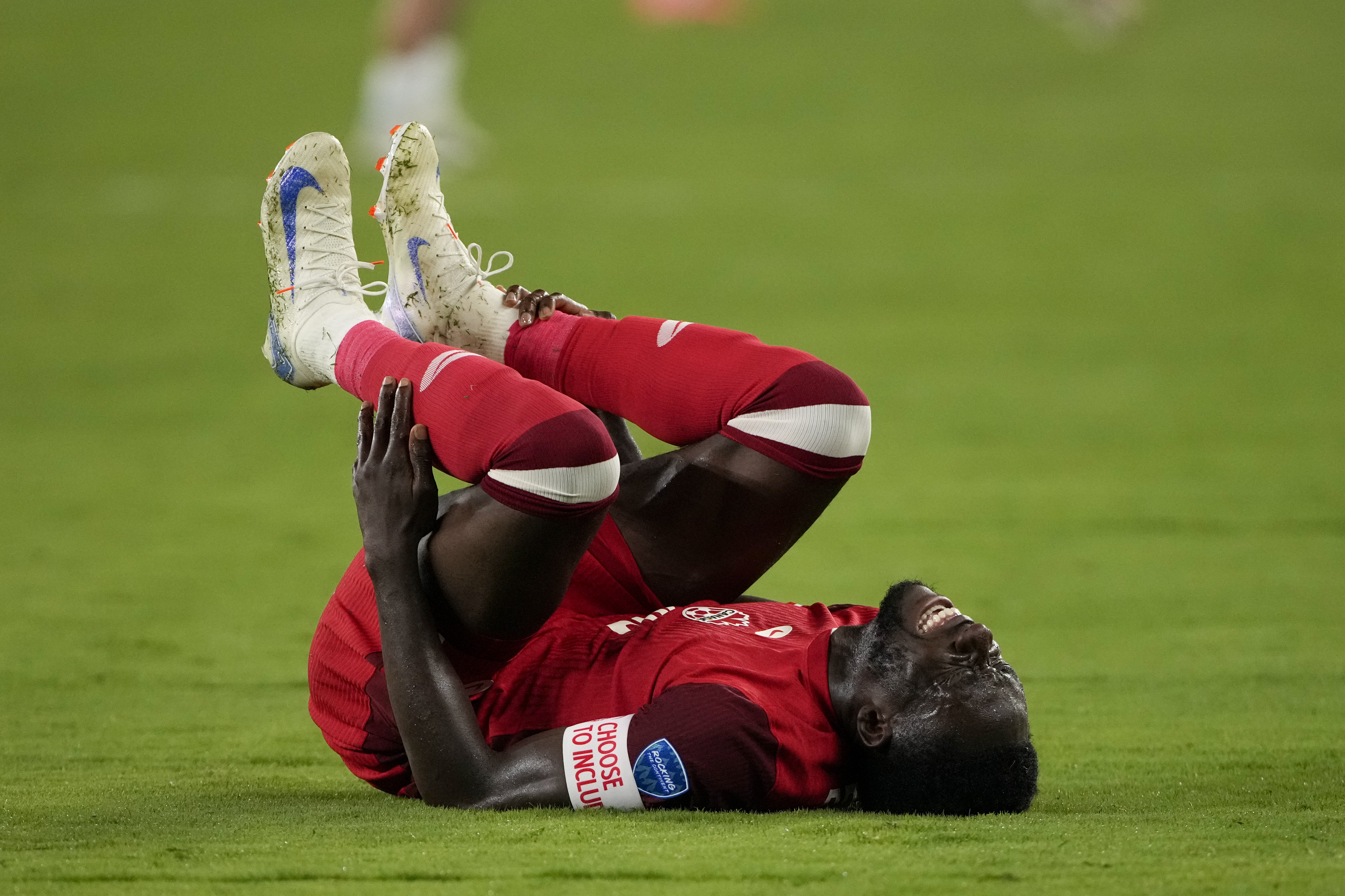 Canada's Alphonso Davies grimaces in pain during a Copa America semifinal soccer match against Argentina in East Rutherford, N.J., Tuesday, July 9, 2024. 