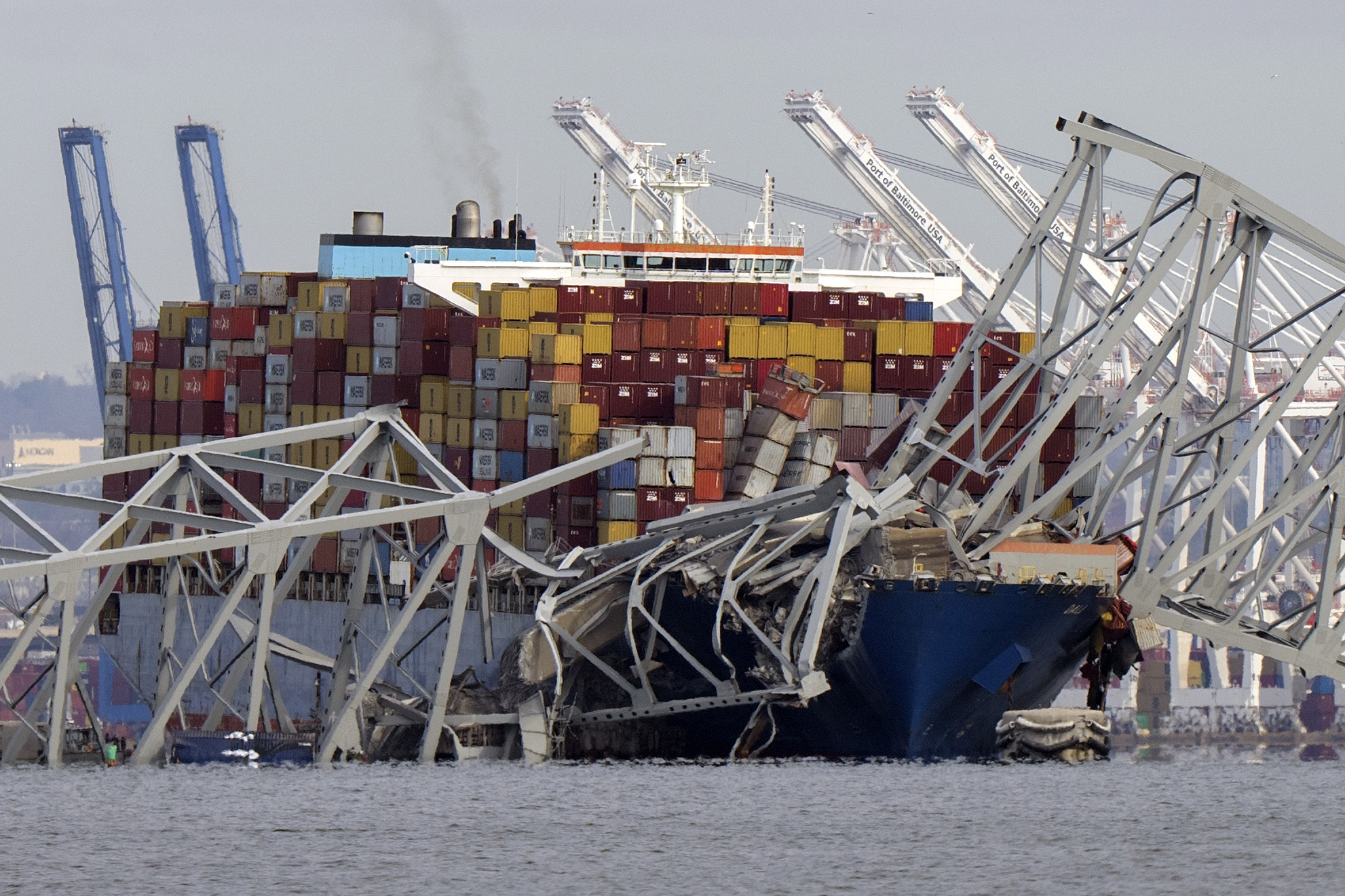 The cargo ship Dali is stuck under part of the structure of the Francis Scott Key Bridge after the ship hit the bridge, March 26, as seen from Pasadena, Md. Julio Cervantes Suarez is the only person who survived falling from the bridge during its catastrophic collapse.