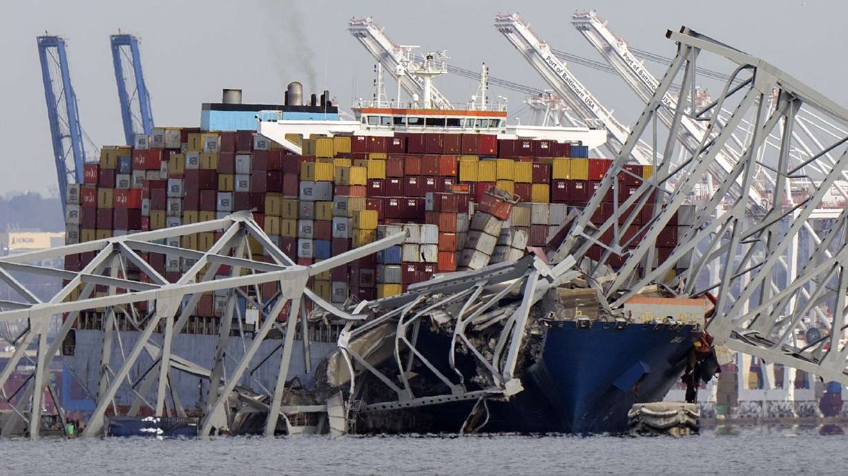 The cargo ship Dali is stuck under part of the structure of the Francis Scott Key Bridge after the ship hit the bridge, March 26, as seen from Pasadena, Md. Julio Cervantes Suarez is the only person who survived falling from the bridge during its catastrophic collapse.