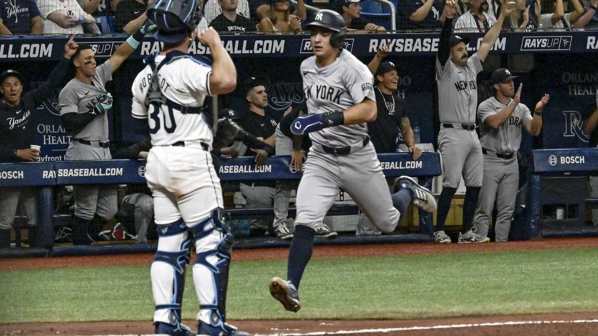 Tampa Bay Rays catcher Ben Rortvedt (30) looks on as New York Yankees' Anthony Volpe scores on Trent Grisham's RBI double during the second inning of a baseball game Wednesday, July 10, 2024, in St. Petersburg, Fla.