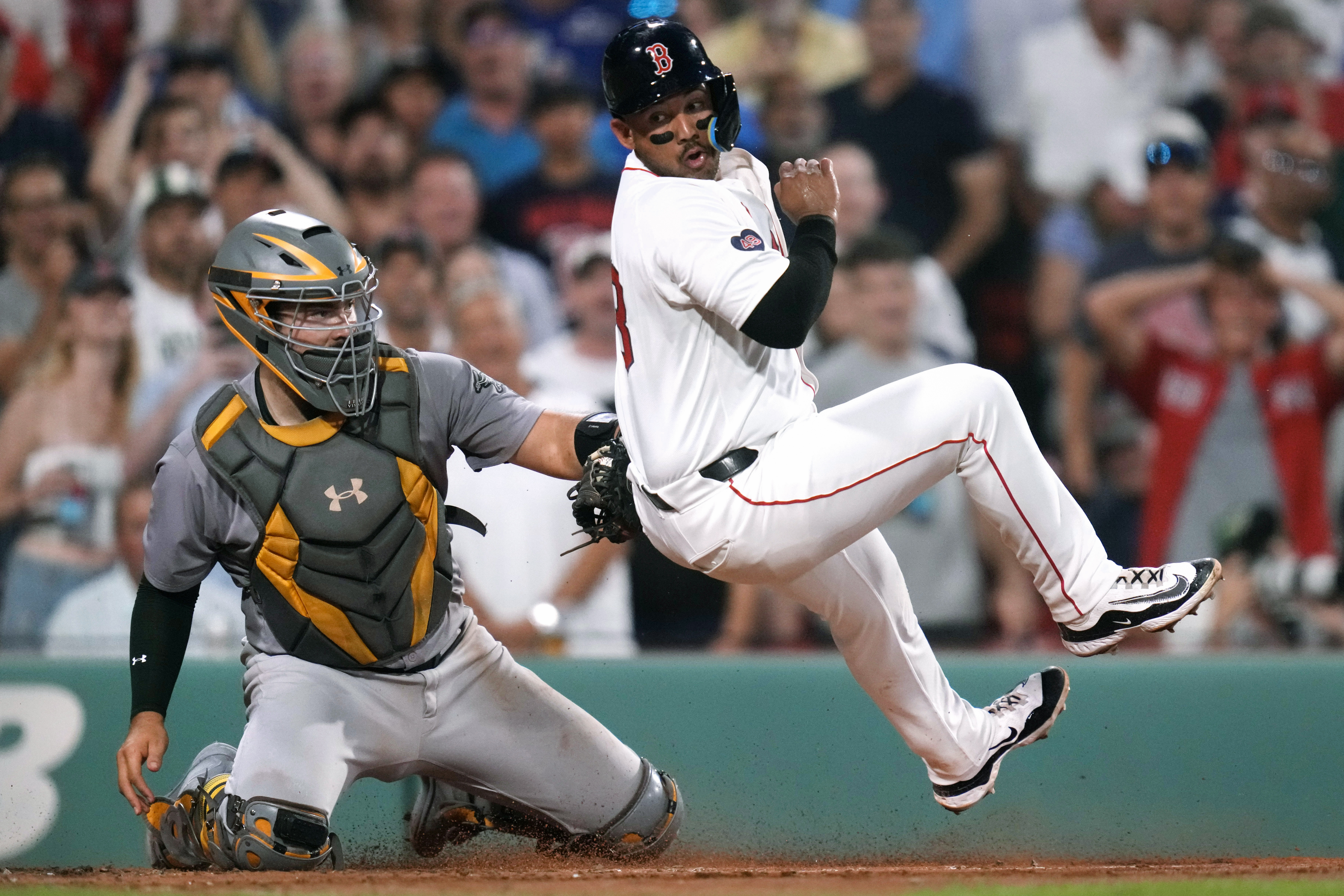 Oakland Athletics catcher Shea Langeliers, left, tags out Boston Red Sox's Jamie Westbrook as he attempts to roll away while trying to score on double by Ceddanne Rafaela during the fifth inning of a baseball game at Fenway Park, Wednesday, July 10, 2024, in Boston. 