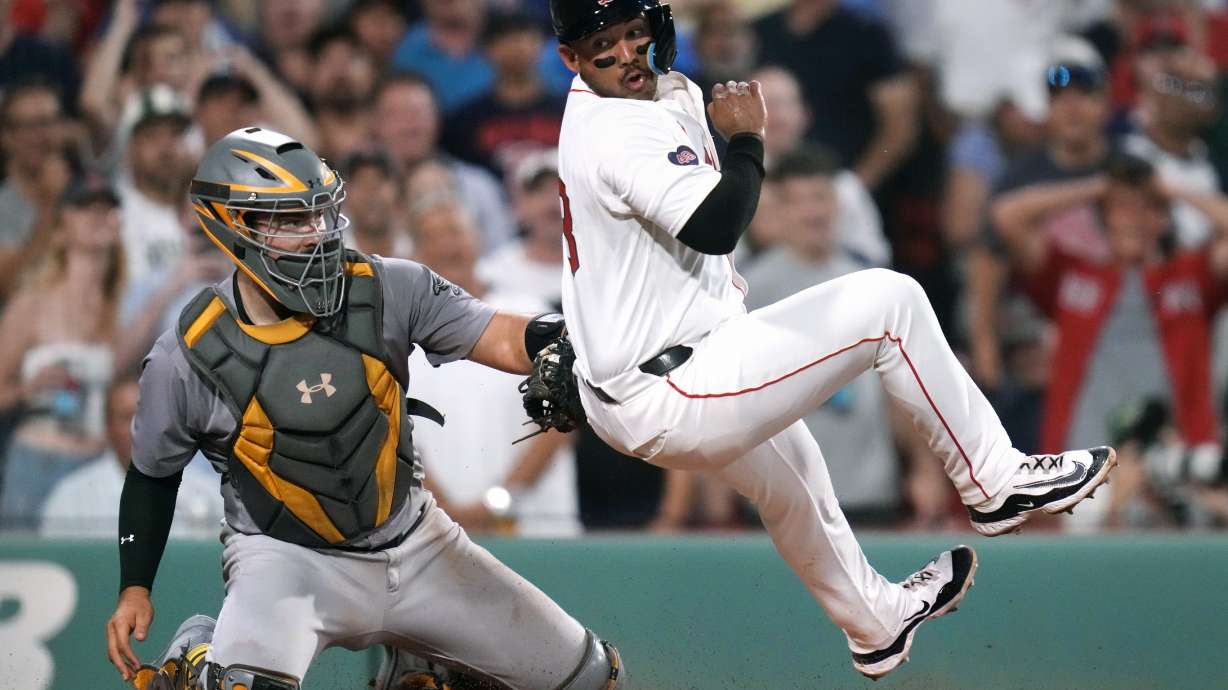 Oakland Athletics catcher Shea Langeliers, left, tags out Boston Red Sox's Jamie Westbrook as he attempts to roll away while trying to score on double by Ceddanne Rafaela during the fifth inning of a baseball game at Fenway Park, Wednesday, July 10, 2024, in Boston.
