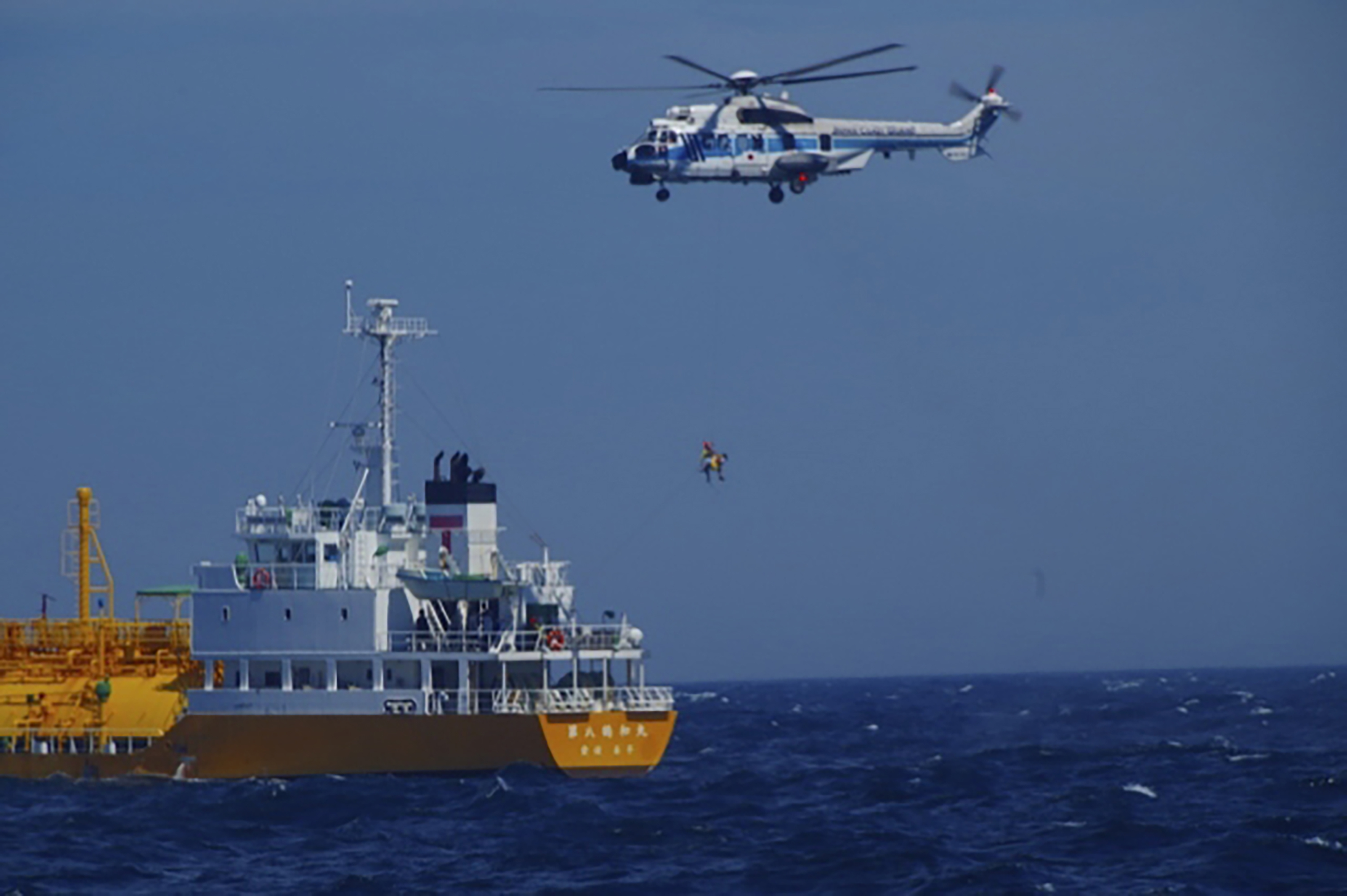 A woman is airlifted by a coast guard helicopter off Nojimazaki, Chiba prefecture, Japan Wednesday. She was swept out to sea while swimming at a Japanese beach and was rescued 37 hours later after drifting in a swimming ring 50 miles away. 