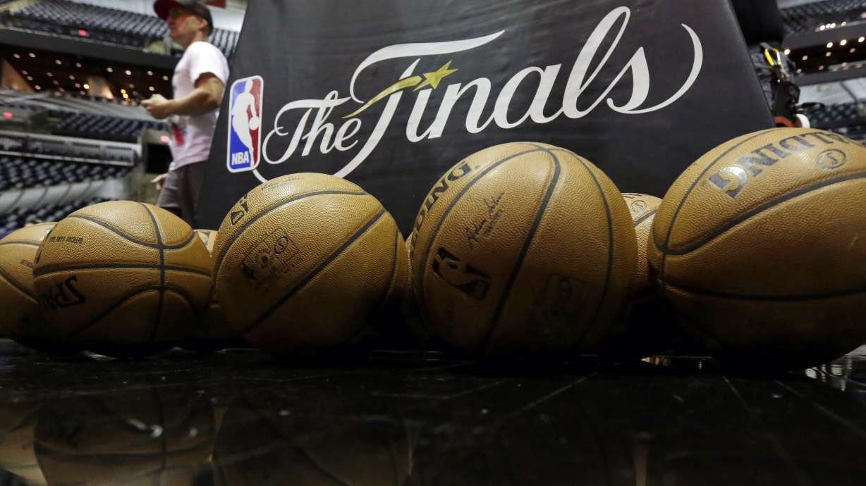 FILE - NBA basketballs and the NBA Finals logo are seen on the court prior to Game 1 of the NBA Finals basketball series between the San Antonio Spurs and Miami Heat, Thursday, June 5, 2014, in San Antonio. The NBA has agreed to terms on its new media deal, an 11-year agreement worth $76 billion that assures player salaries will continue rising for the foreseeable future and one that will surely change how some viewers access the game for years to come.