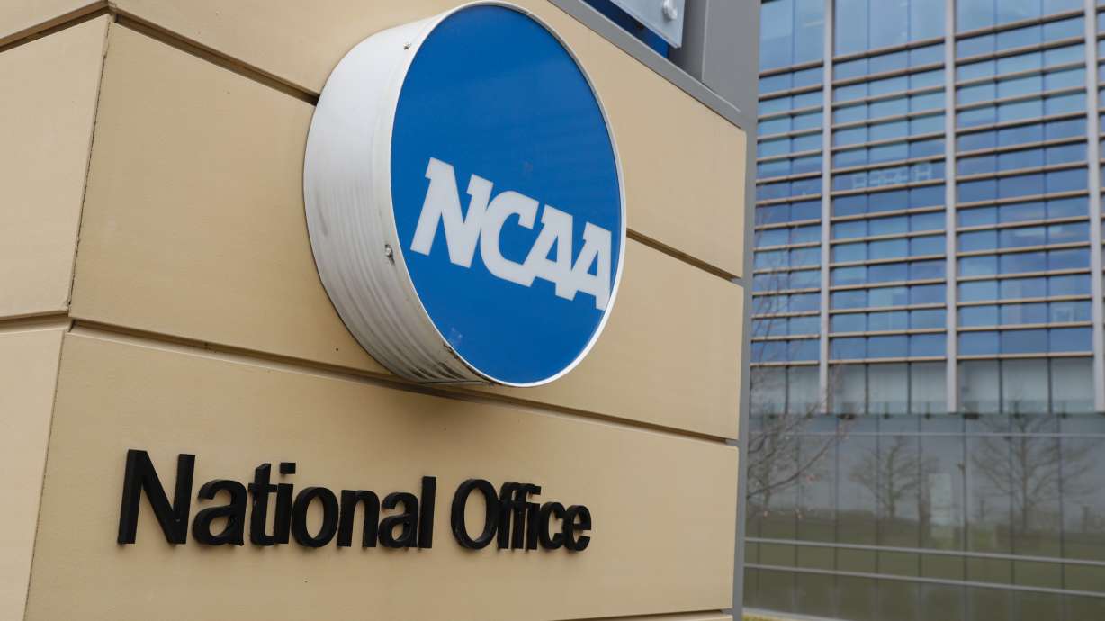 FILE - Signage at the headquarters of the NCAA is viewed in Indianapolis, March 12, 2020. A U.S. appeals court in Philadelphia has ruled that some college athletes may qualify as employees under federal wage-and-hour laws. The court says a test should be developed to differentiate students who play college sports for fun from those whose effort “crosses the legal line into work” that benefits the school. The NCAA had hoped to have the case dismissed.