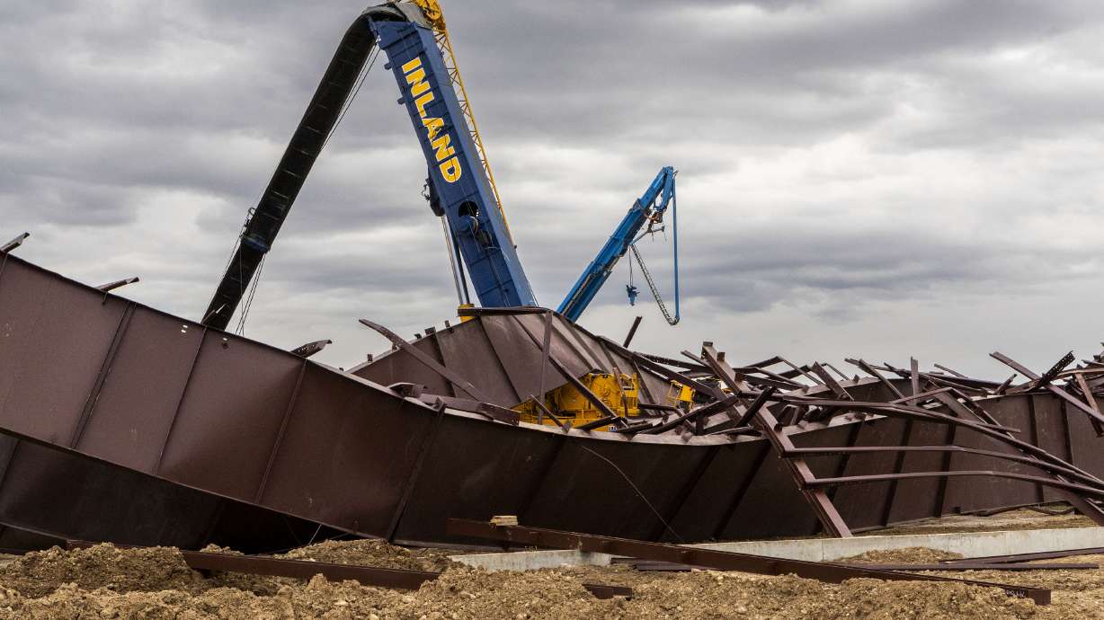 Twisted girders and debris cover the ground the day after a deadly structure collapse at a construction site near the Boise Airport, Feb. 1 in Boise, Idaho. On Tuesday, the families of two construction workers killed when the airport hangar collapsed filed suit against several companies.