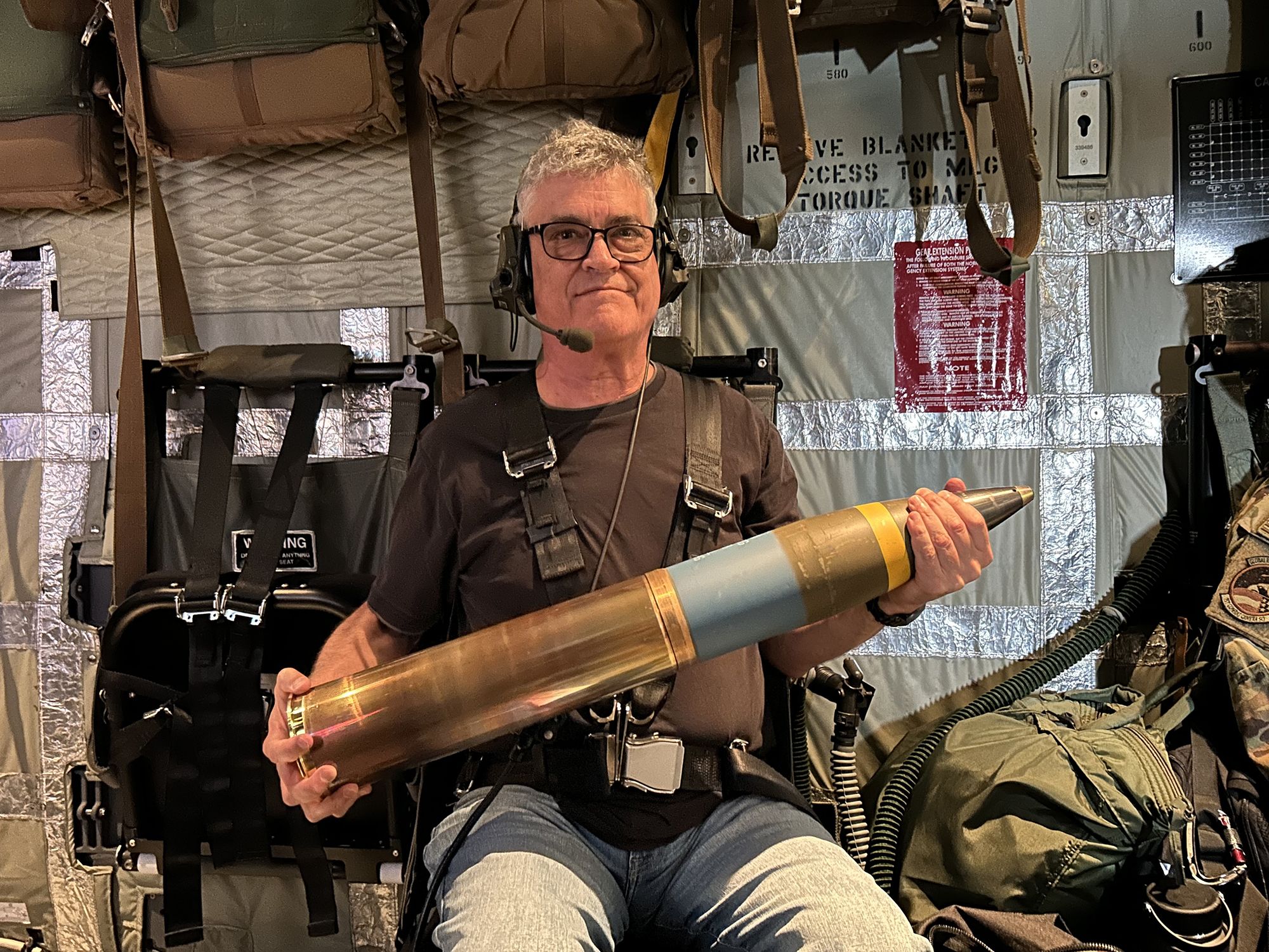 CNN senior global military affairs writer Brad Lendon holds a 105mm howitzer shell aboard a U.S. Air Force AC-130J gunship flying out of Osan Air Base, South Korea, in June.