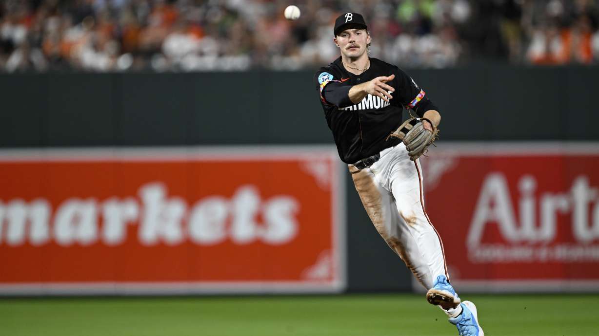 Baltimore Orioles shortstop Gunnar Henderson throws to first base for an out on a ground ball hit by Texas Rangers' Leody Taveras during the seventh inning of a baseball game, Saturday, June 29, 2024, in Baltimore.