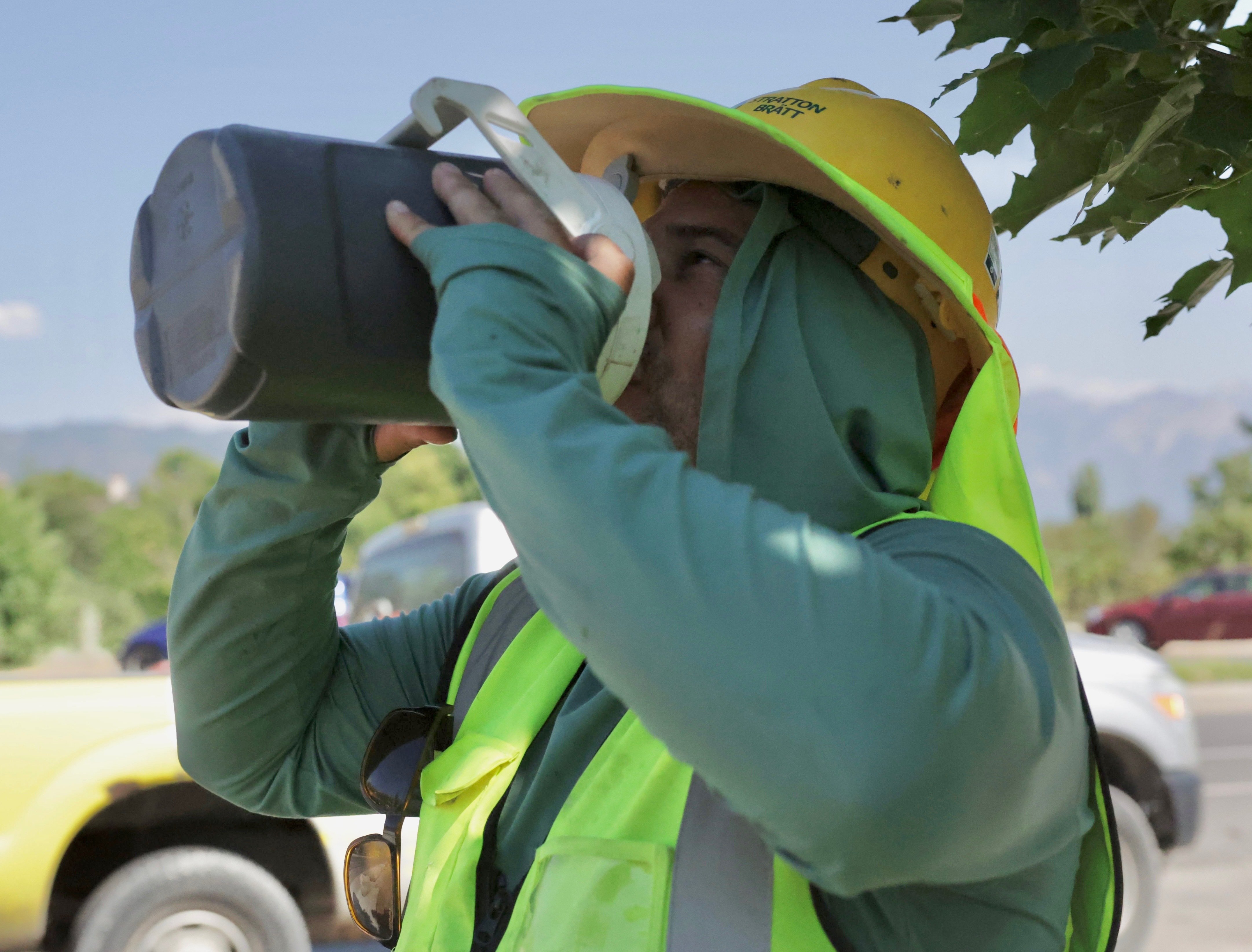 Cristian Ortega, from Orem, takes a water break in the shade while working on construction at the Utah Capitol grounds Thursday after Salt Lake City officially hit 106 degrees, breaking the old record of 104 set in 2021.