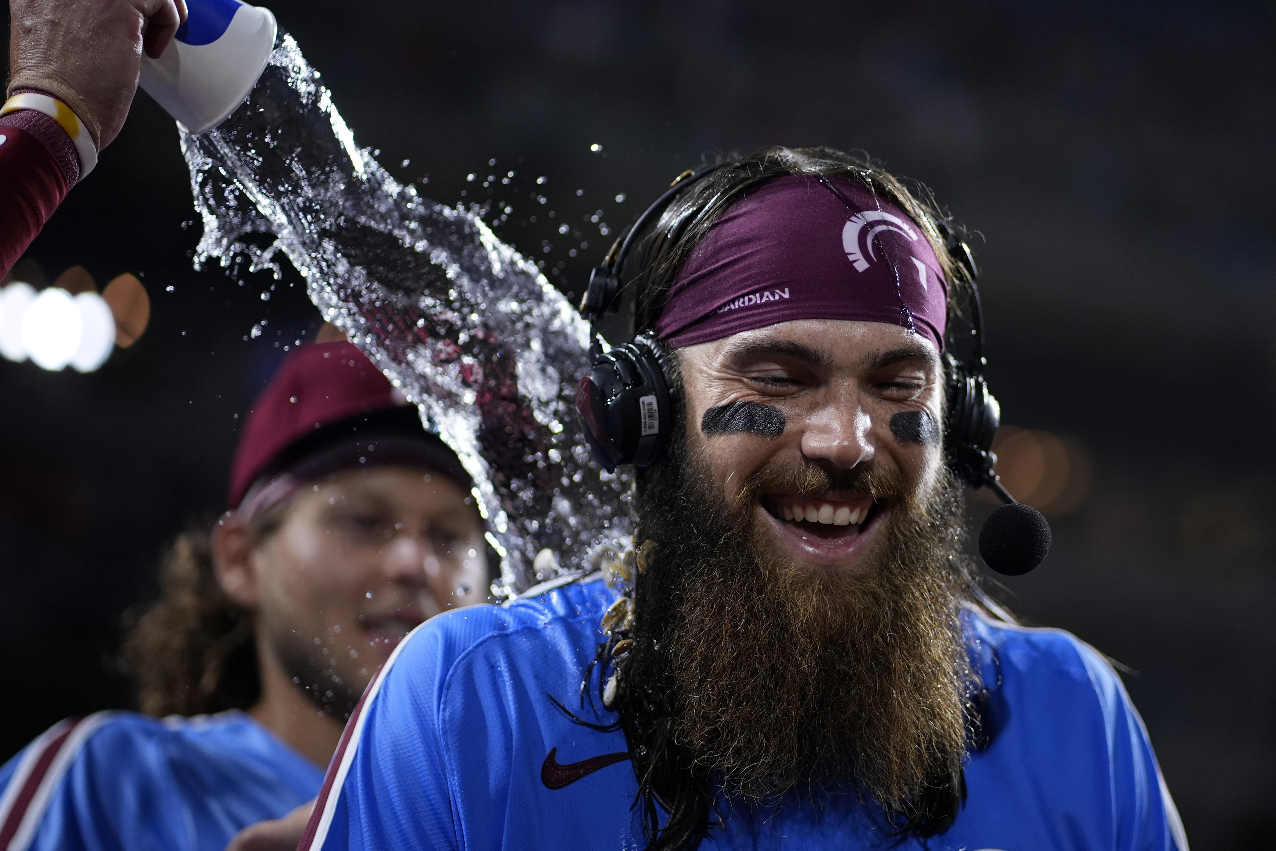 Philadelphia Phillies' Brandon Marsh is doused by Bryson Stott after the Phillies won a baseball game against the Los Angeles Dodgers, Thursday, July 11, 2024, in Philadelphia. 