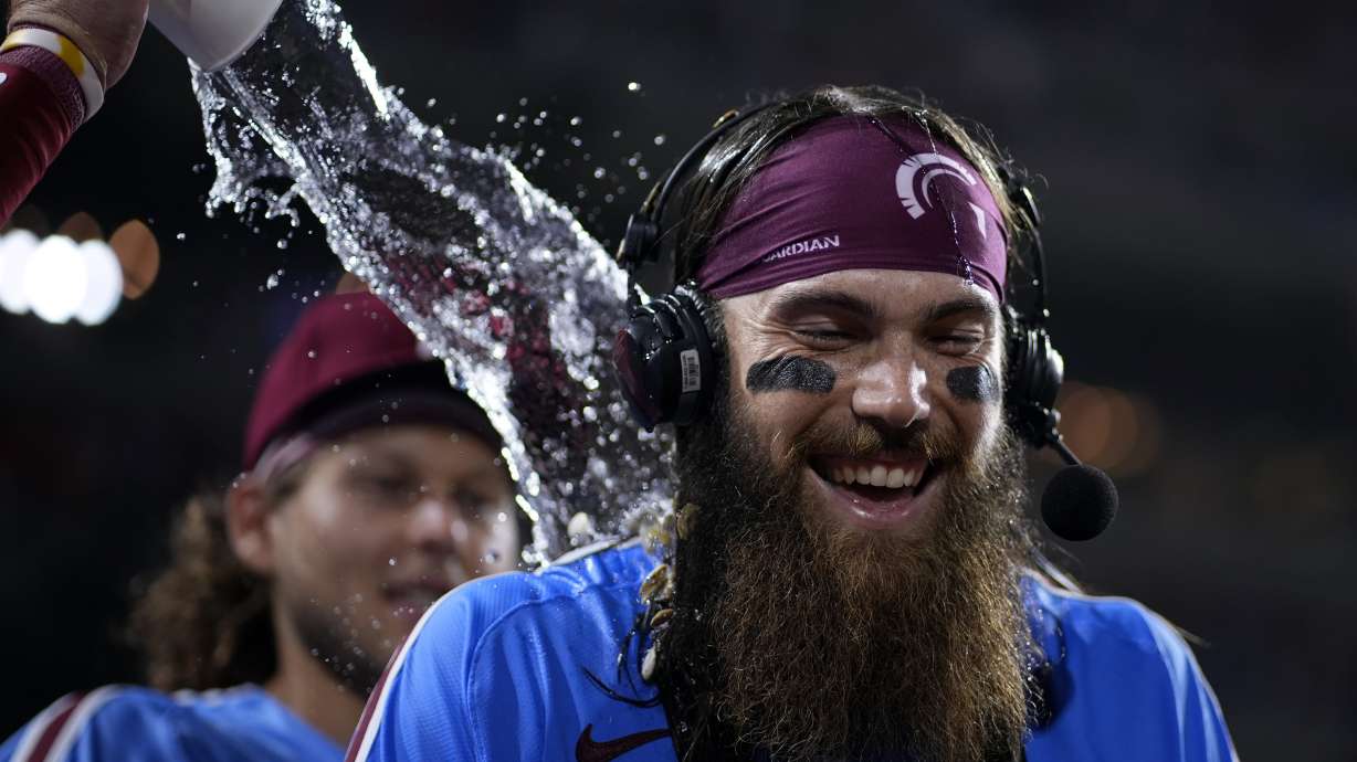 Philadelphia Phillies' Brandon Marsh is doused by Bryson Stott after the Phillies won a baseball game against the Los Angeles Dodgers, Thursday, July 11, 2024, in Philadelphia.