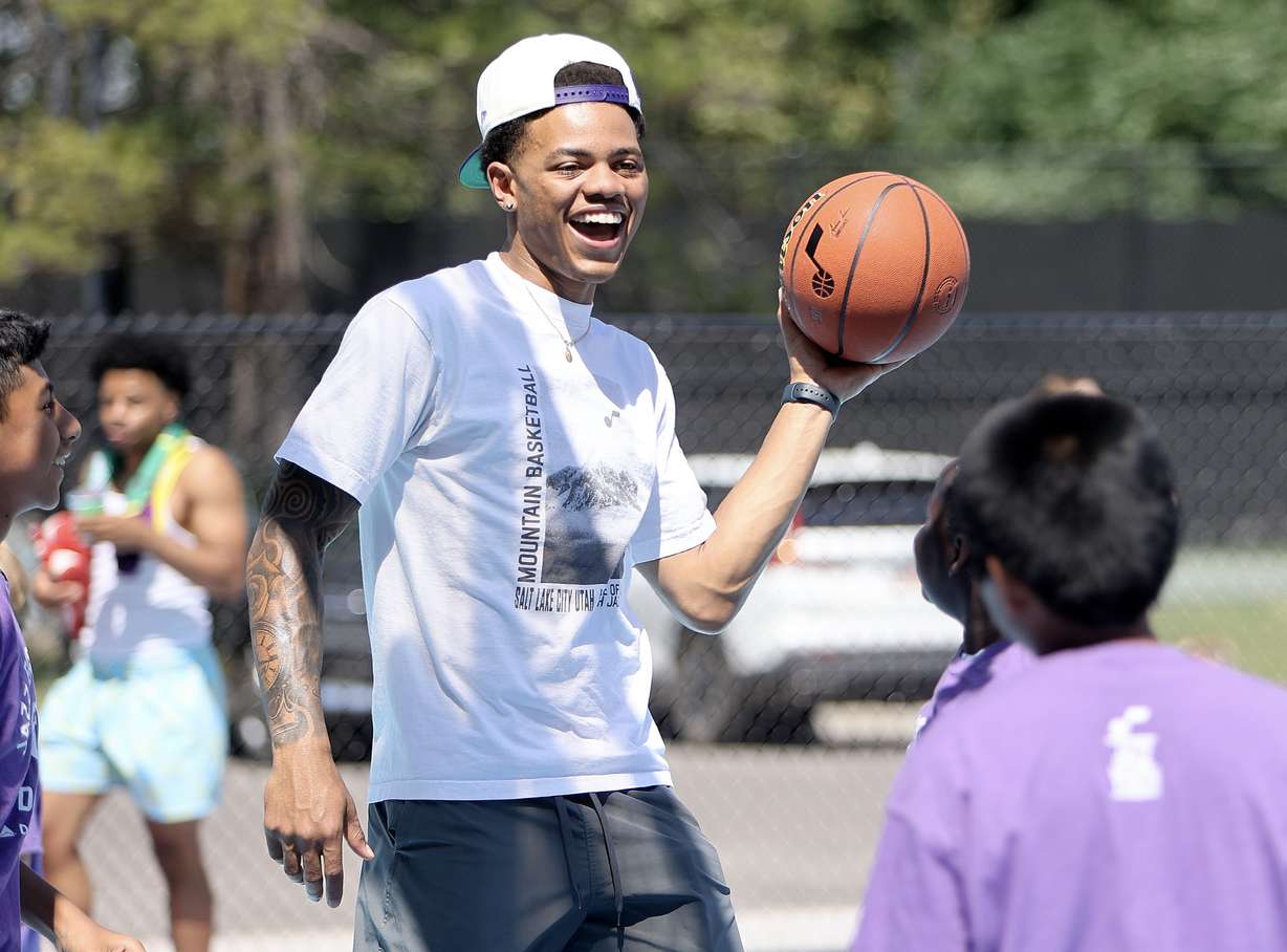 Utah Jazz guard Keyonte George plays basketball with YouthCity kids after a ribbon-cutting ceremony for a renovated community basketball court at Liberty Park in Salt Lake City on Thursday.