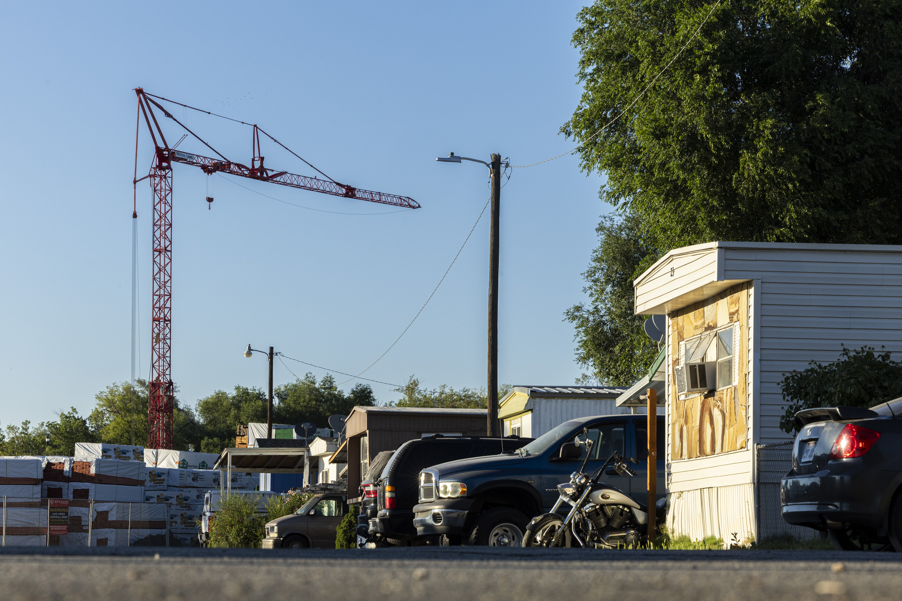 A crane stands at a construction site next to the Cedarwood Mobile Home Park in Layton on July 2.