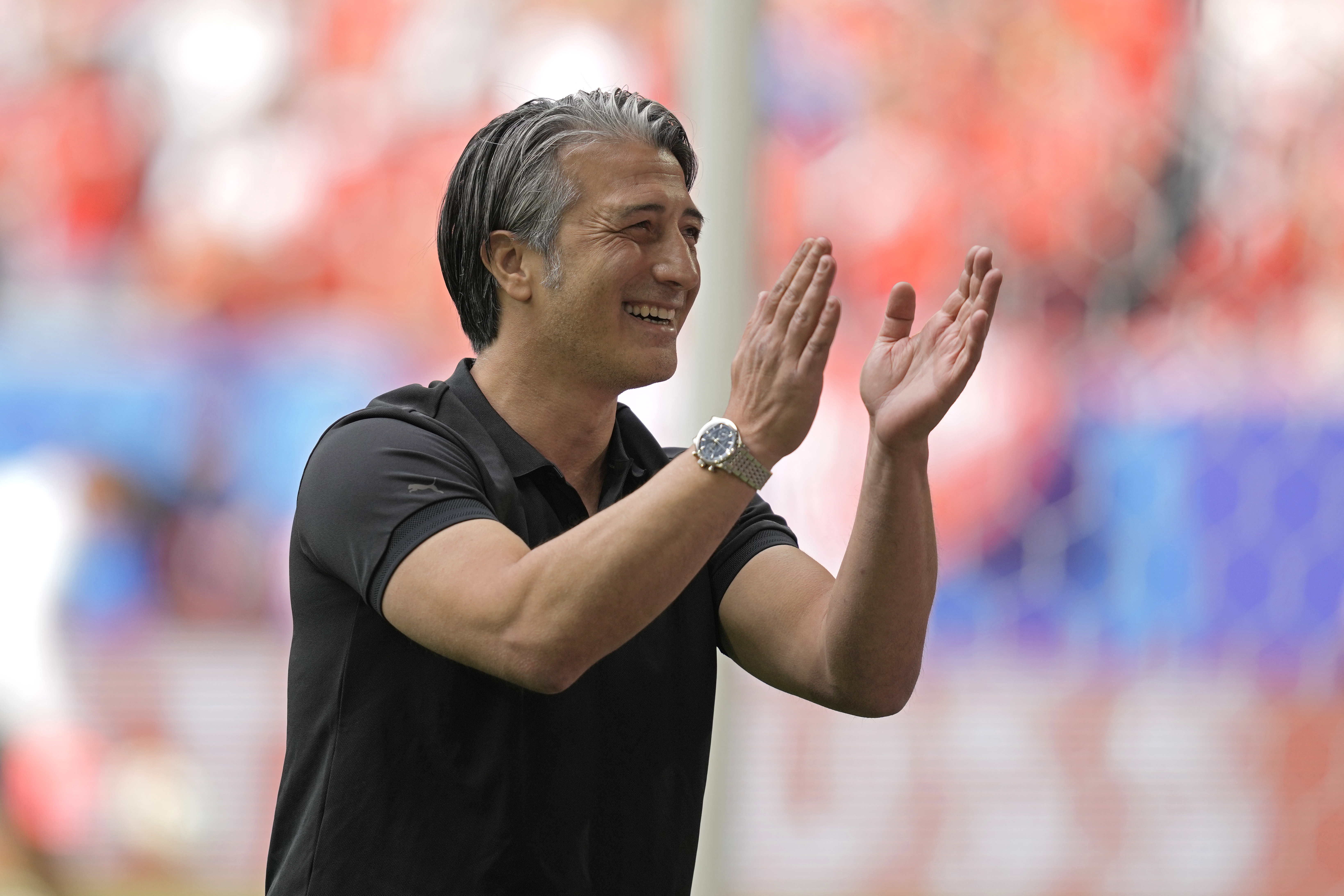 Switzerland's head coach Murat Yakin reacts to the fans before the start of the quarterfinal match between England and Switzerland at the Euro 2024 soccer tournament in Duesseldorf, Germany, Saturday, July 6, 2024.