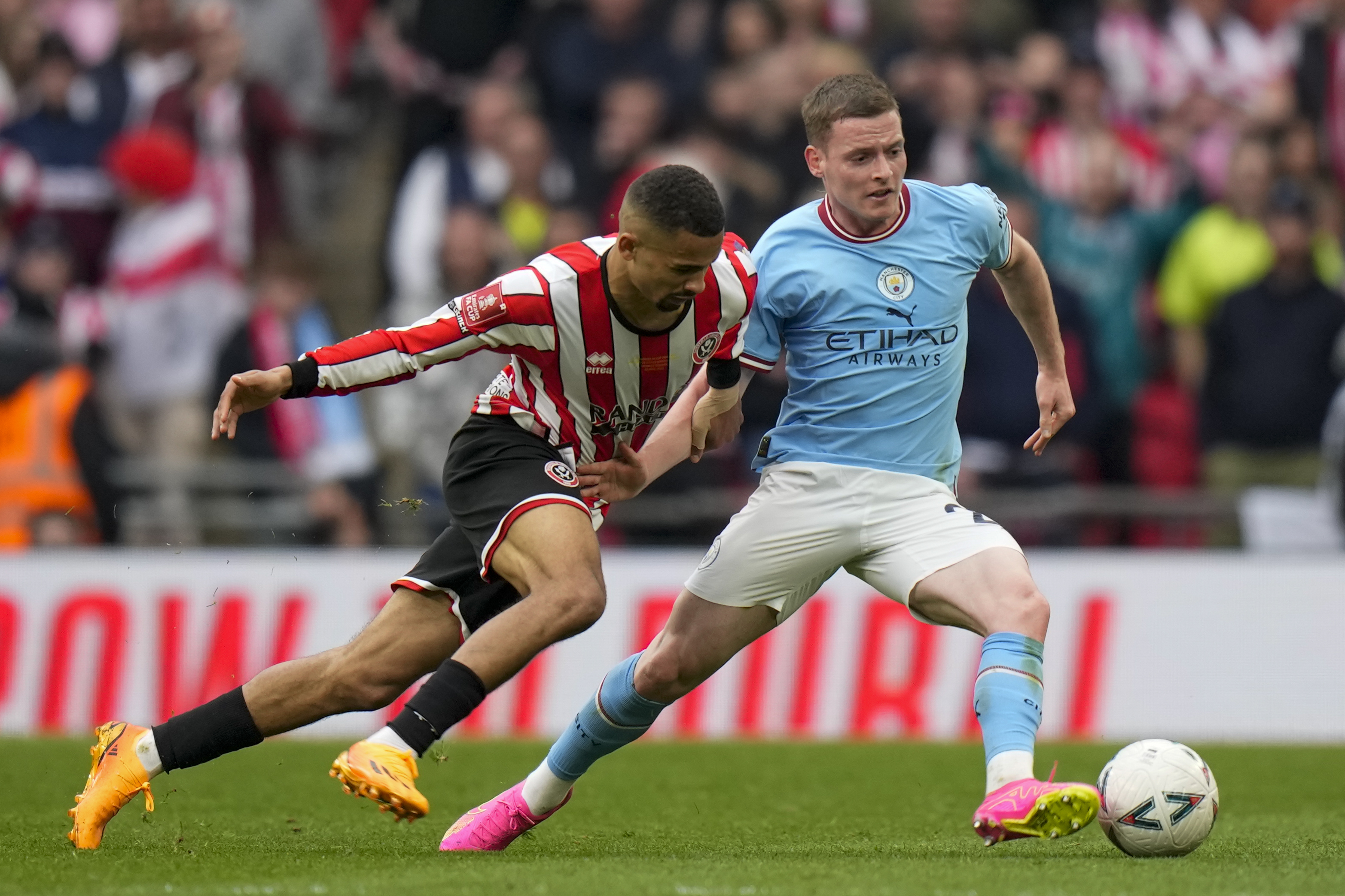 FILE - Manchester City's Sergio Gomez, right, and Sheffield United's Iliman Ndiaye, left, duels for the ball with during the English FA Cup semi final soccer match between Manchester City and Sheffield United at Wembley stadium, in London, on April 22, 2023. Sergio Gomez has left Manchester City to join Real Sociedad on a permanent deal. 