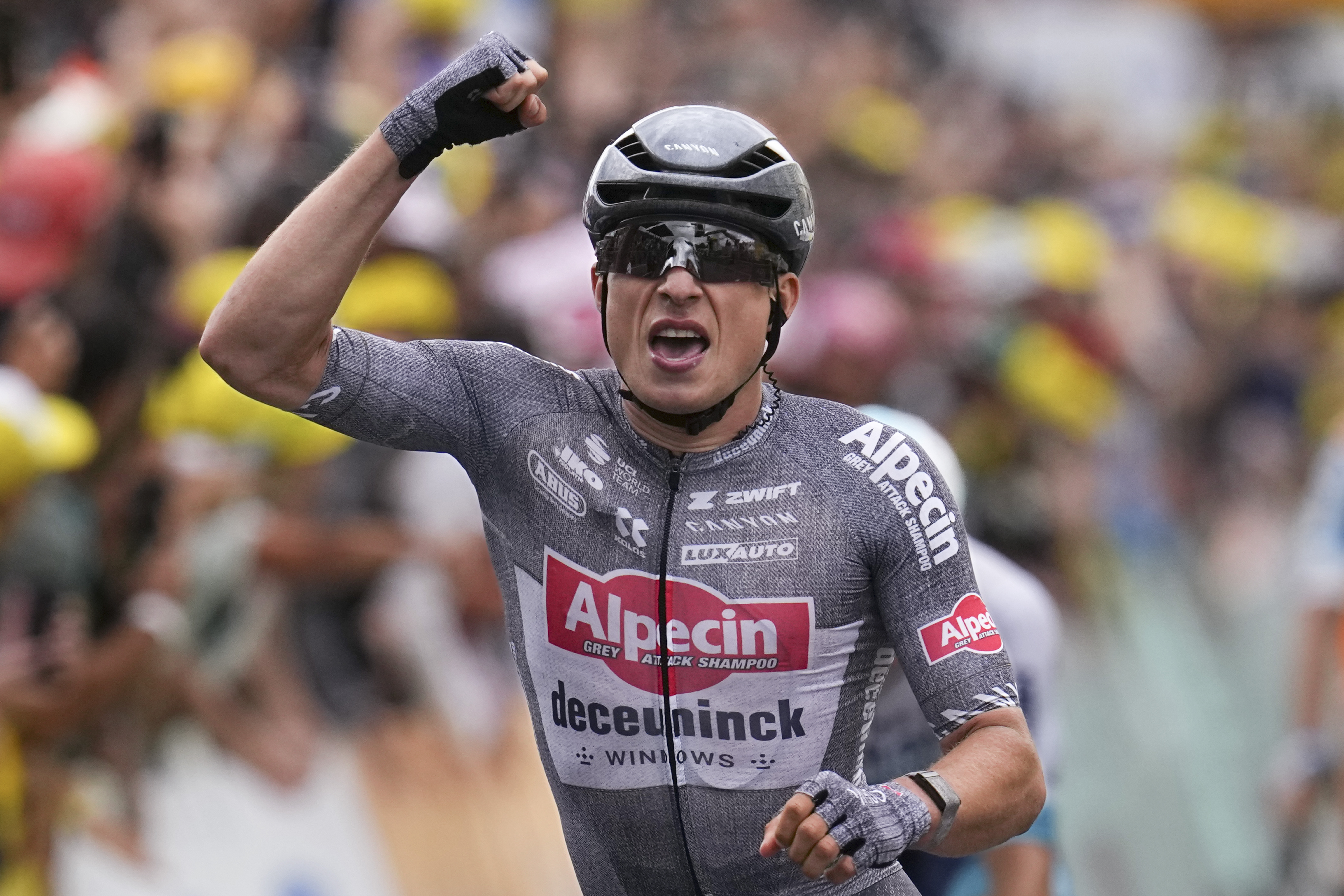 Belgium's Jasper Philipsen celebrates as he crosses the finish line to win the thirteenth stage of the Tour de France cycling race over 165.3 kilometers (102.7 miles) with start in Agen and finish Pau, France, Friday, July 12, 2024.