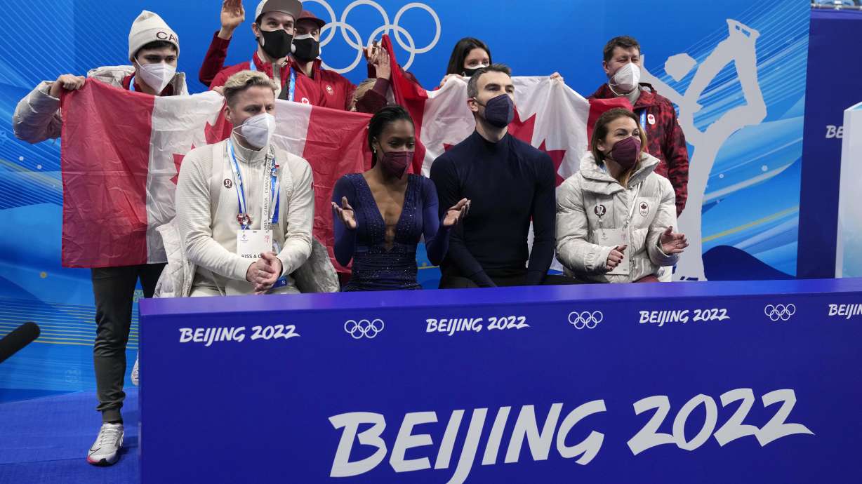 FILE - Canada's Vanessa James, second from left front row, and Eric Radford, second from right front row, react after the pairs team free skate program during the figure skating competition at the 2022 Winter Olympics, Monday, Feb. 7, 2022, in Beijing. A hearing on July 22 for eight Canadian skaters seeking to get team event bronze medals will be held in the Swiss city Lausanne, the Court of Arbitration for Sport said Friday, July 12, 2024.