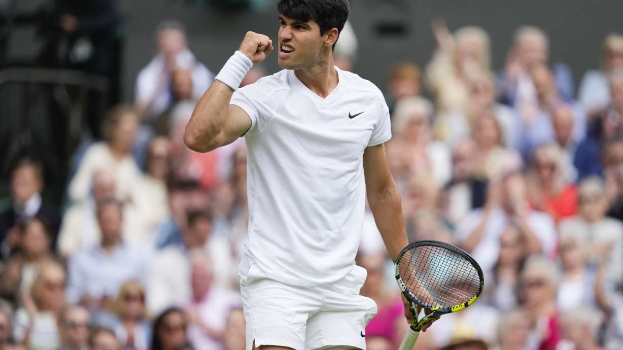Carlos Alcaraz of Spain reacts during his semifinal match against Daniil Medvedev of Russia at the Wimbledon tennis championships in London, Friday, July 12, 2024.