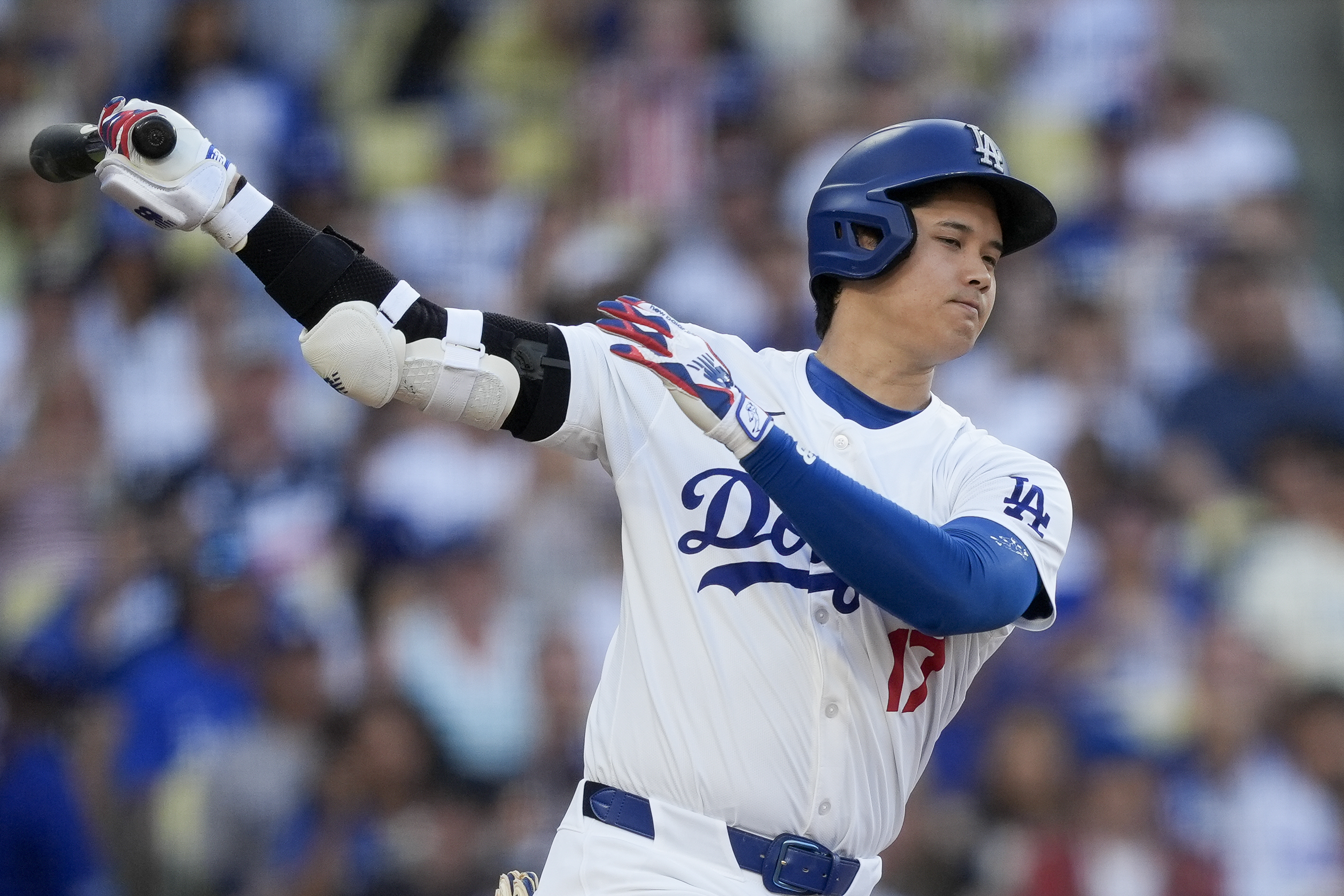 Los Angeles Dodgers designated hitter Shohei Ohtani strikes out swinging during the third inning of a baseball game against the Arizona Diamondbacks, Thursday, July 4, 2024, in Los Angeles. 