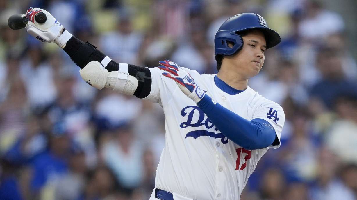 Los Angeles Dodgers designated hitter Shohei Ohtani strikes out swinging during the third inning of a baseball game against the Arizona Diamondbacks, Thursday, July 4, 2024, in Los Angeles.