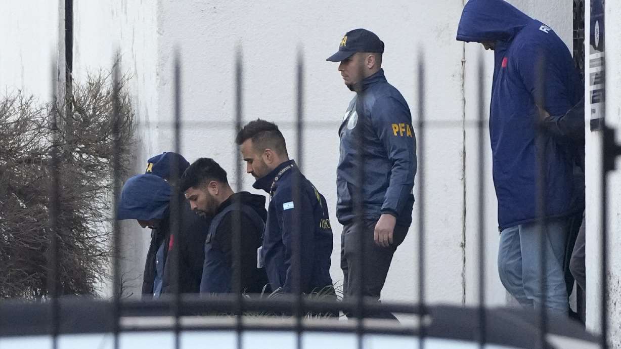 Police escort French rugby players Oscar Jegou, left, and Hugo Auradou, right, in Buenos Aires, Argentina, Thursday, July 11, 2024. The players were arrested following a formal complaint filed against them for alleged sexual assault, after France played Argentina in a test rugby match in Mendoza on July 6.