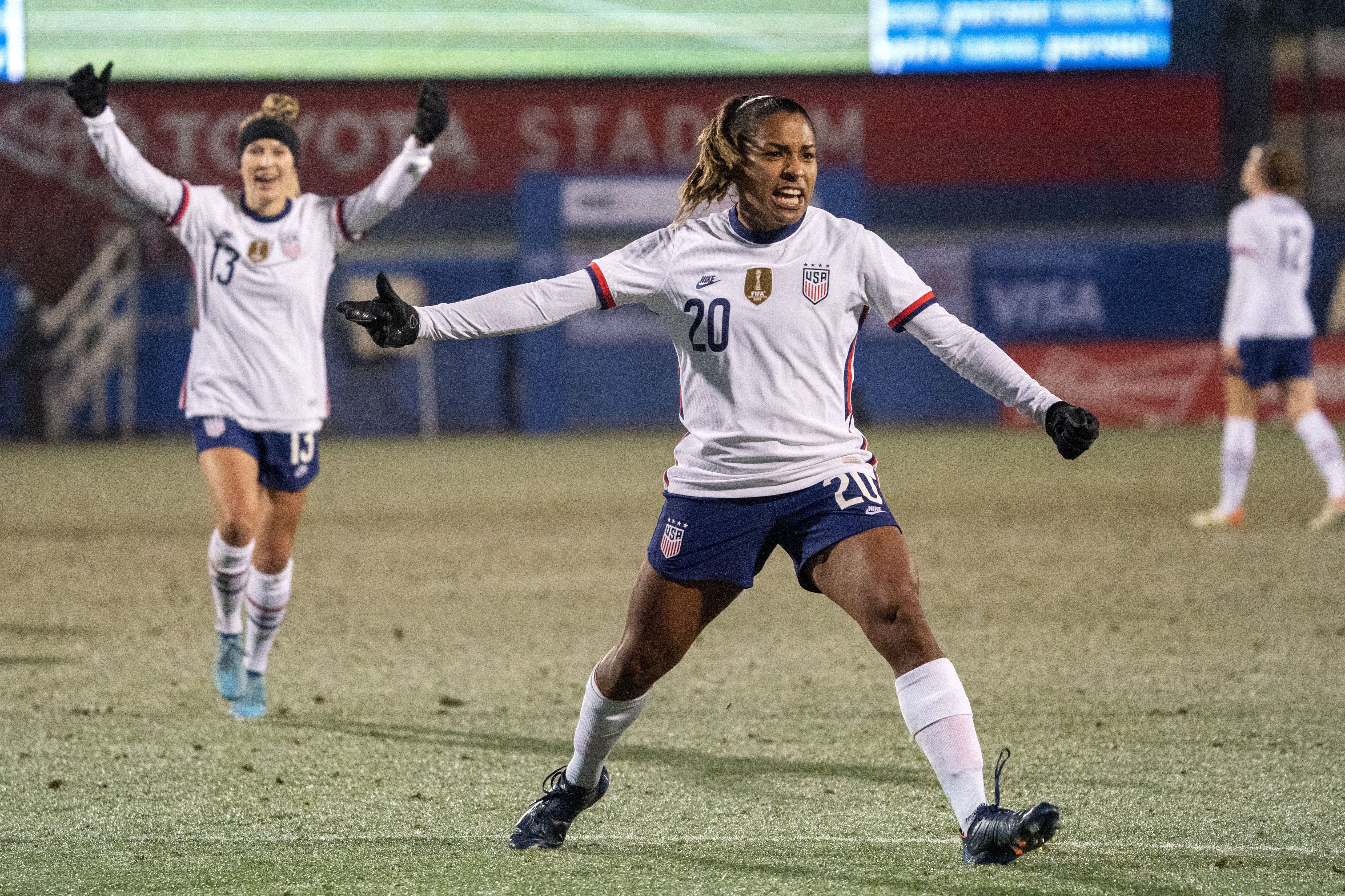 FILE - United States forward Catarina Macario (20) and midfielder Ashley Sanchez (13) celebrate Macario's goal during the first half of a She Believes Cup soccer match against Iceland at Toyota Stadium, Wednesday, Feb. 23, 2022 in Frisco, Texas. Forward Catarina Macario won't be able to train for the Olympics because of irritation in her right knee, U.S. coach Emma Hayes announced on Friday, July 12, 2024. 
