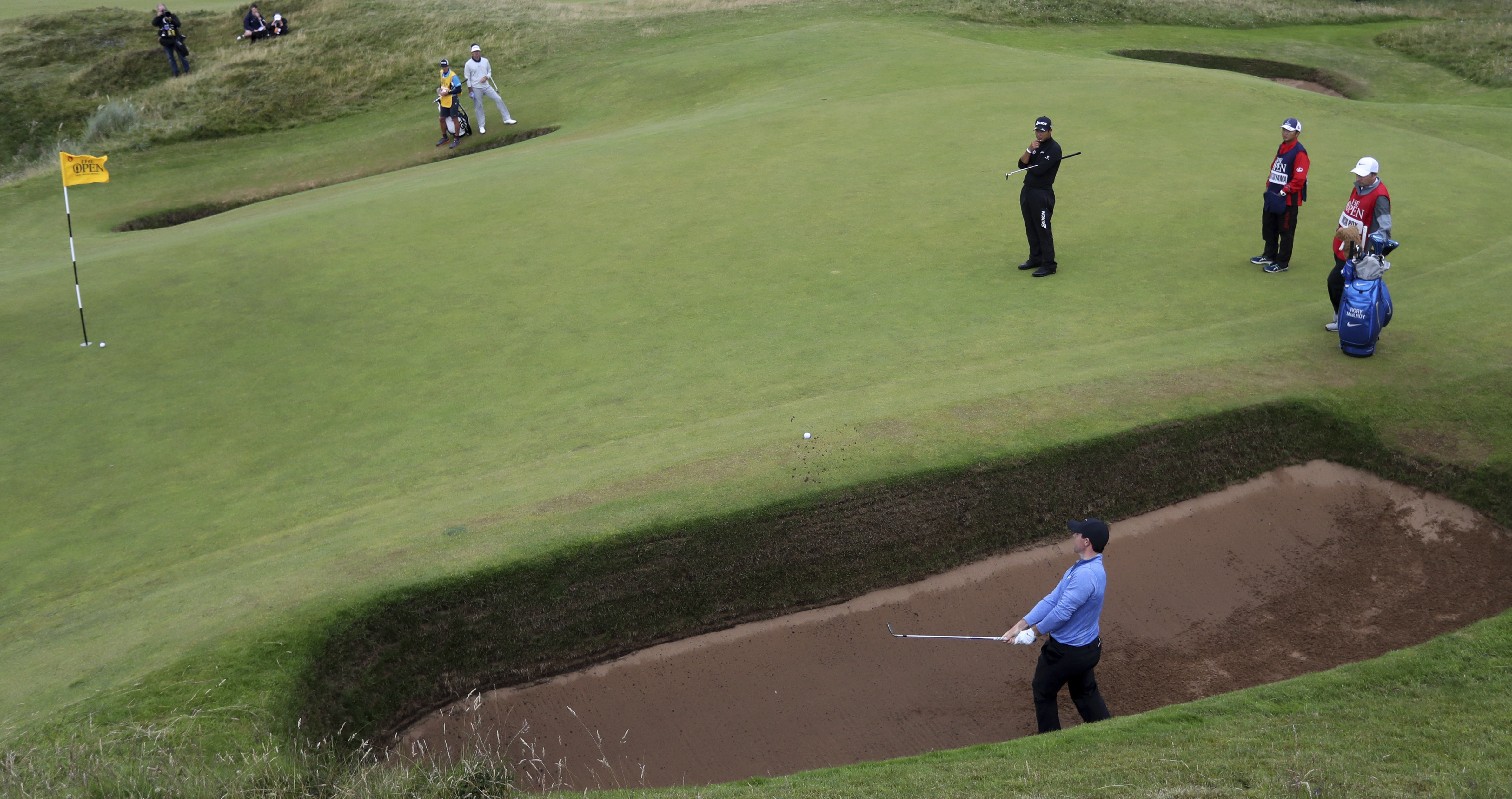 FILE - Rory McIlroy, of Northern Ireland, hits out of bunker onto the eighth green during the second round of the British Open Golf Championship at the Royal Troon Golf Club in Troon, Scotland, Friday, July 15, 2016. McIlroy returns to Royal Troon while trying to move past his U.S. Open collapse.