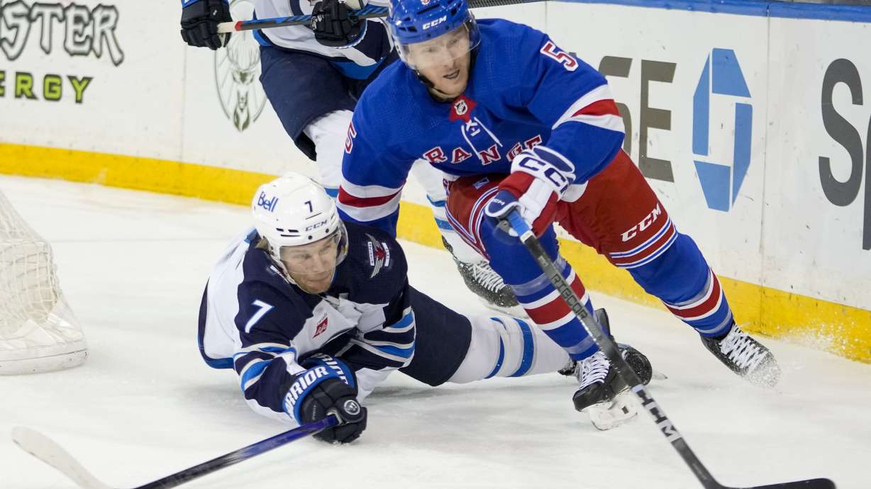 FILE - New York Rangers defenseman Chad Ruhwedel (5) skates against Winnipeg Jets center Vladislav Namestnikov (7) during the first period of an NHL hockey game March 19, 2024, at Madison Square Garden in New York. The Rangers have re-signed veteran defenseman Ruhwedel to a one-year contract. General manager Chris Drury announced the signing Friday, July 12, 2024, in a move that offers 23-year-old Zac Jones competition for a spot on the team's third pairing. Terms were not immediately available.