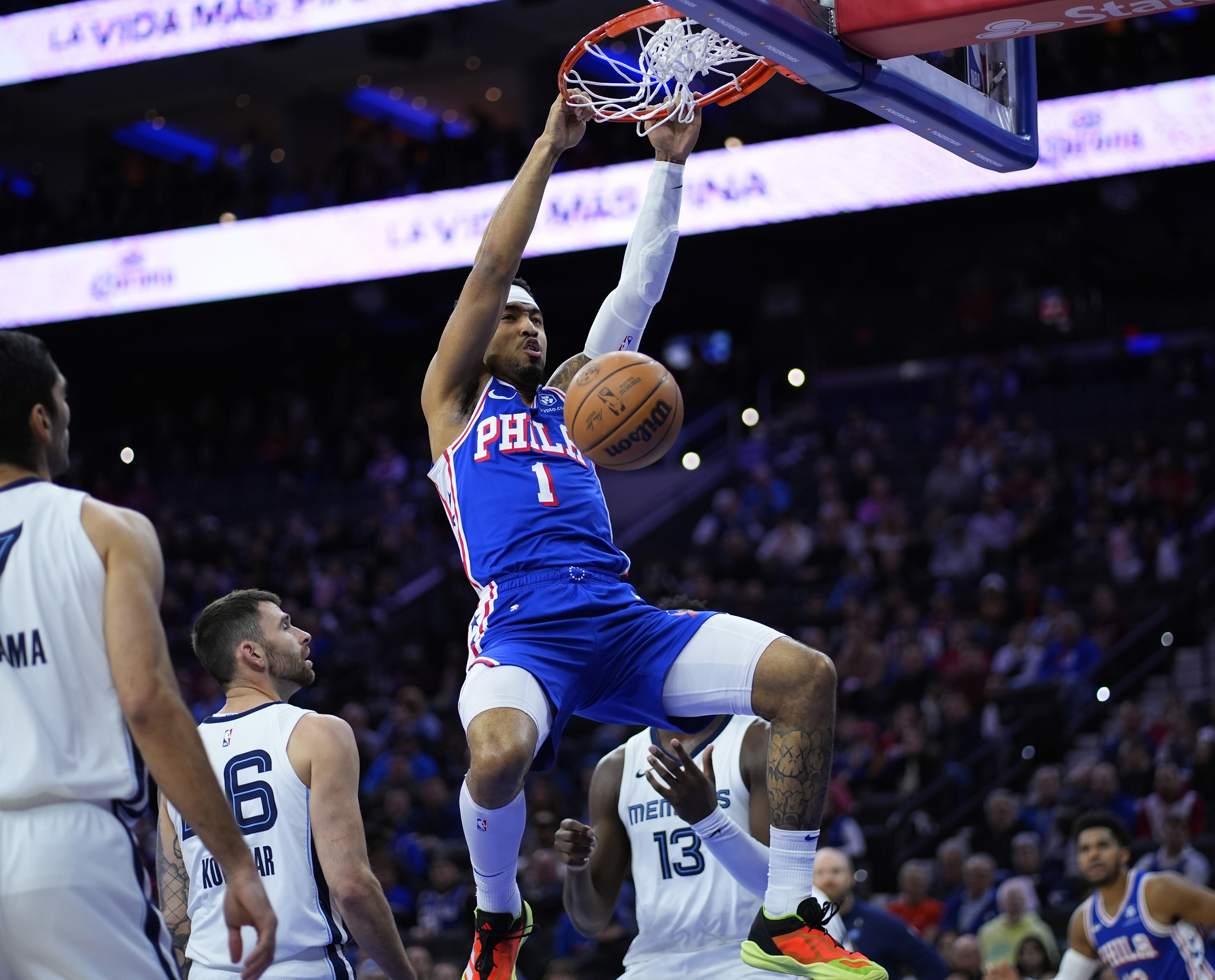 FILE - Philadelphia 76ers' KJ Martin (1) hangs from the rim after dunking during the first half of an NBA basketball game against the Memphis Grizzlies, March 6, 2024, in Philadelphia. The 76ers are keeping at least one player acquired in the James Harden deal, coming to an agreement on a two-year, $16-million contract with forward Martin a person with knowledge of the deal told The Associated Press, Friday, July 12, 2024. 